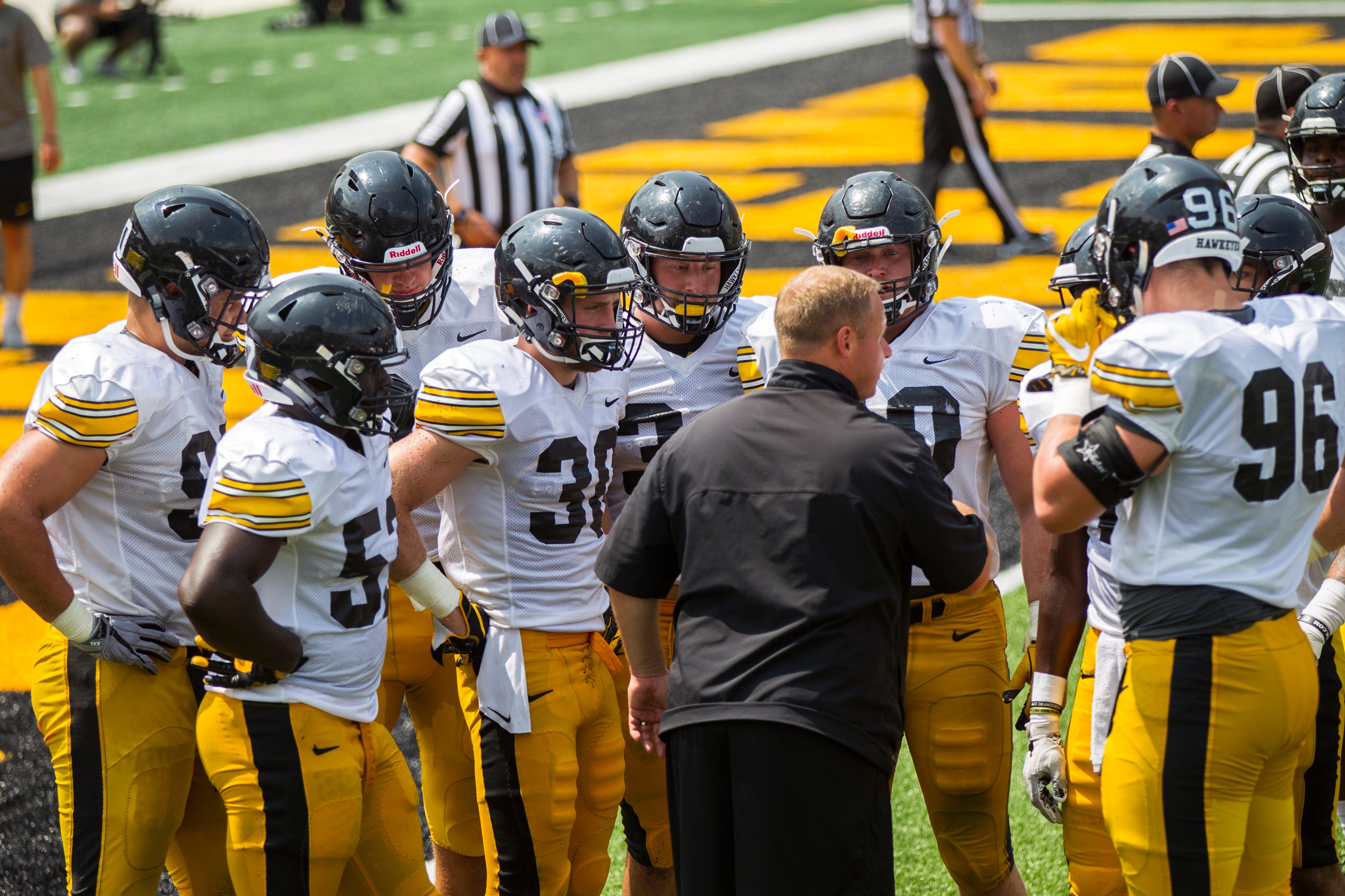 Iowa linebackers coach Seth Wallace talks with players during a Kids Day practice on Saturday, Aug. 11, 2018, at Kinnick Stadium in Iowa City.