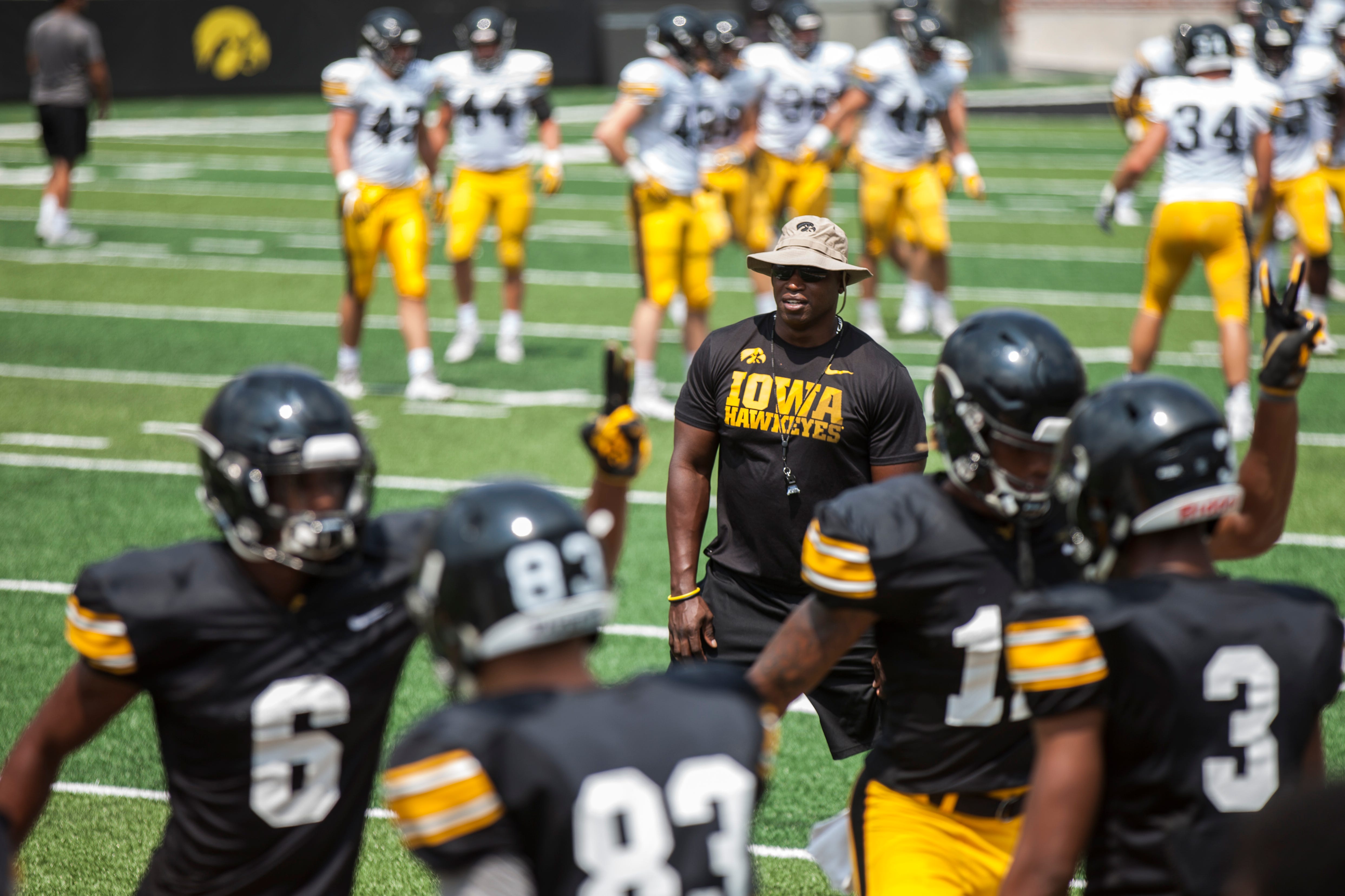 Iowa wide receivers coach Kelton Copeland watches players warm up during a Kids Day practice on Saturday, Aug. 11, 2018, at Kinnick Stadium in Iowa City.