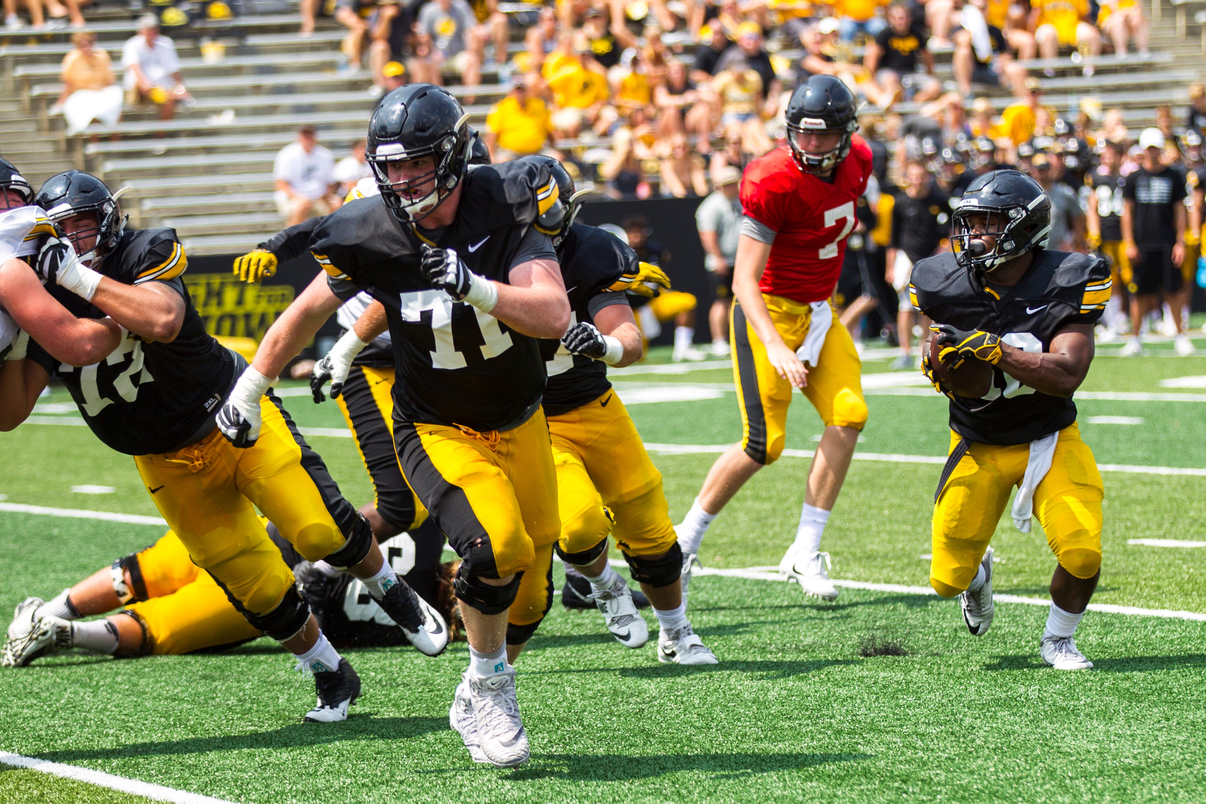Iowa offensive lineman Mark Kallenberger (71) sets up a block for running back Mekhi Sargent (10) during a Kids Day practice on Saturday, Aug. 11, 2018, at Kinnick Stadium in Iowa City.