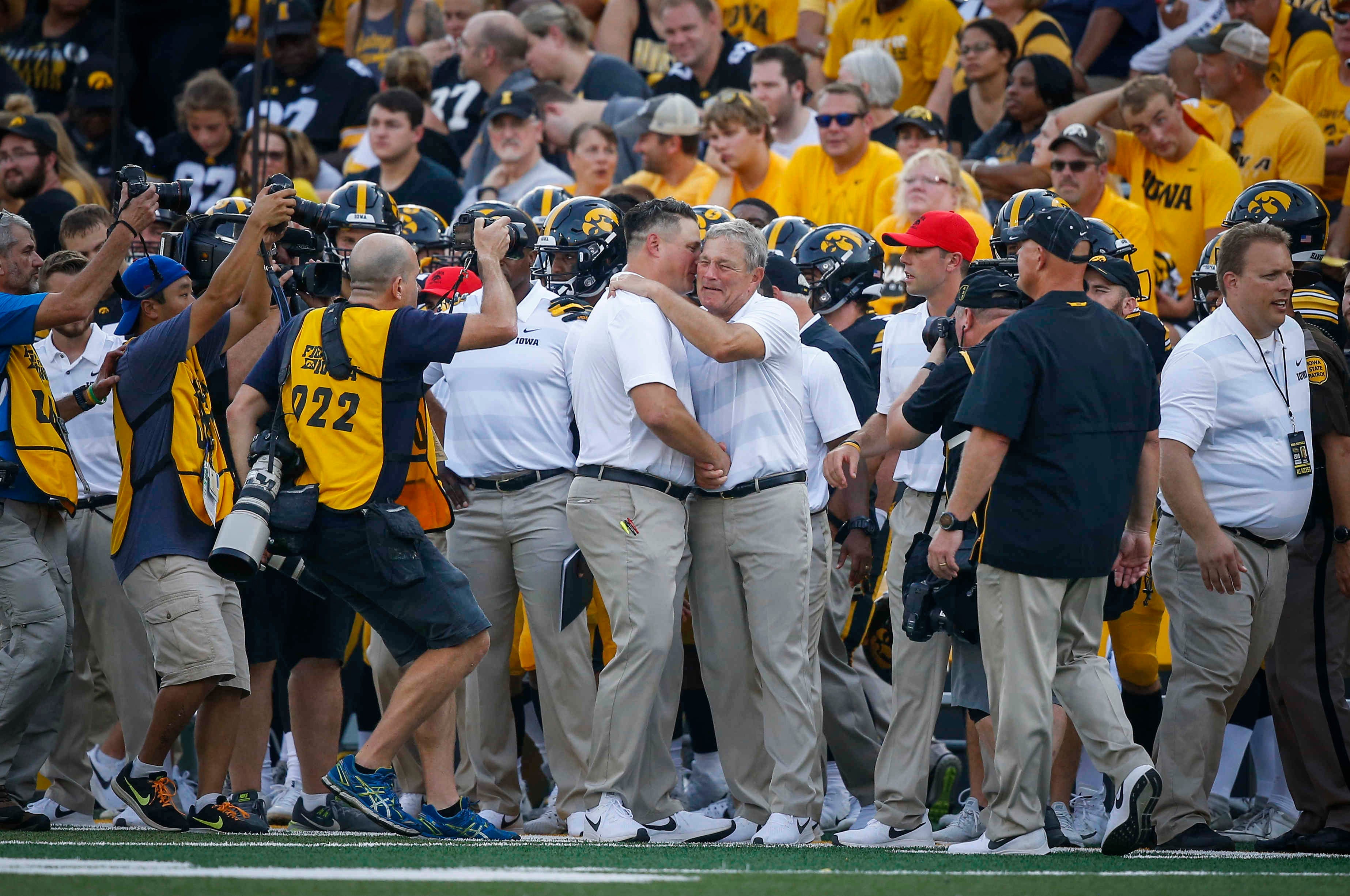 An emotional Iowa head football coach Kirk Ferentz gets a hug from his son and offensive coordinator Brian Ferentz after a 33-7 win over Northern Illinois on Saturday, Sept. 1, 2018, at Kinnick Stadium in Iowa City. The win makes Ferentz the winningest coach in Iowa football history.
