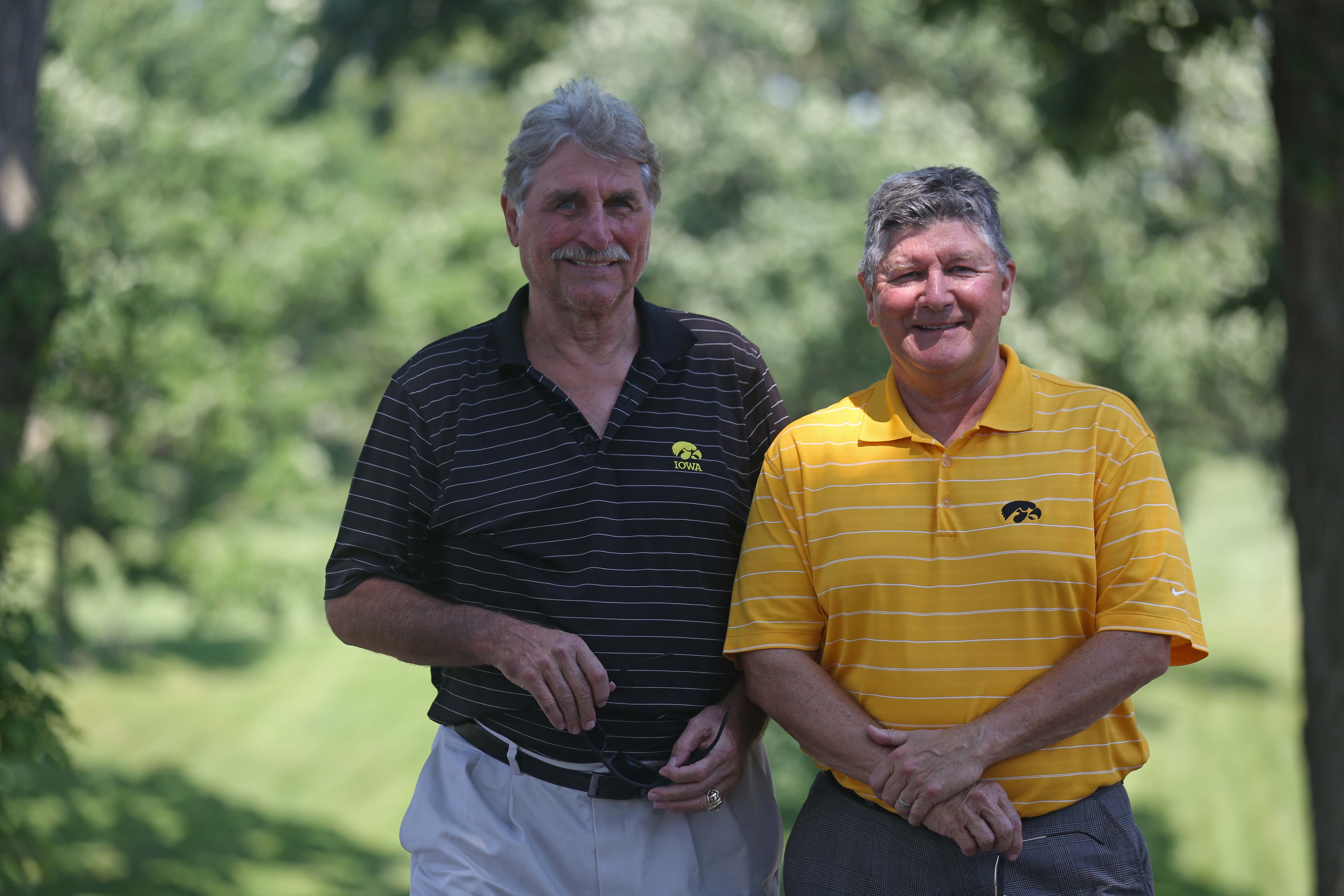Gary Dolphin and Ed Podolak, radio announcers for the University of Iowa football team pose for a photo during the annual Polk County I-Club golf fundraiser at Wakonda Club in Des Moines on Monday, June 13, 2015.