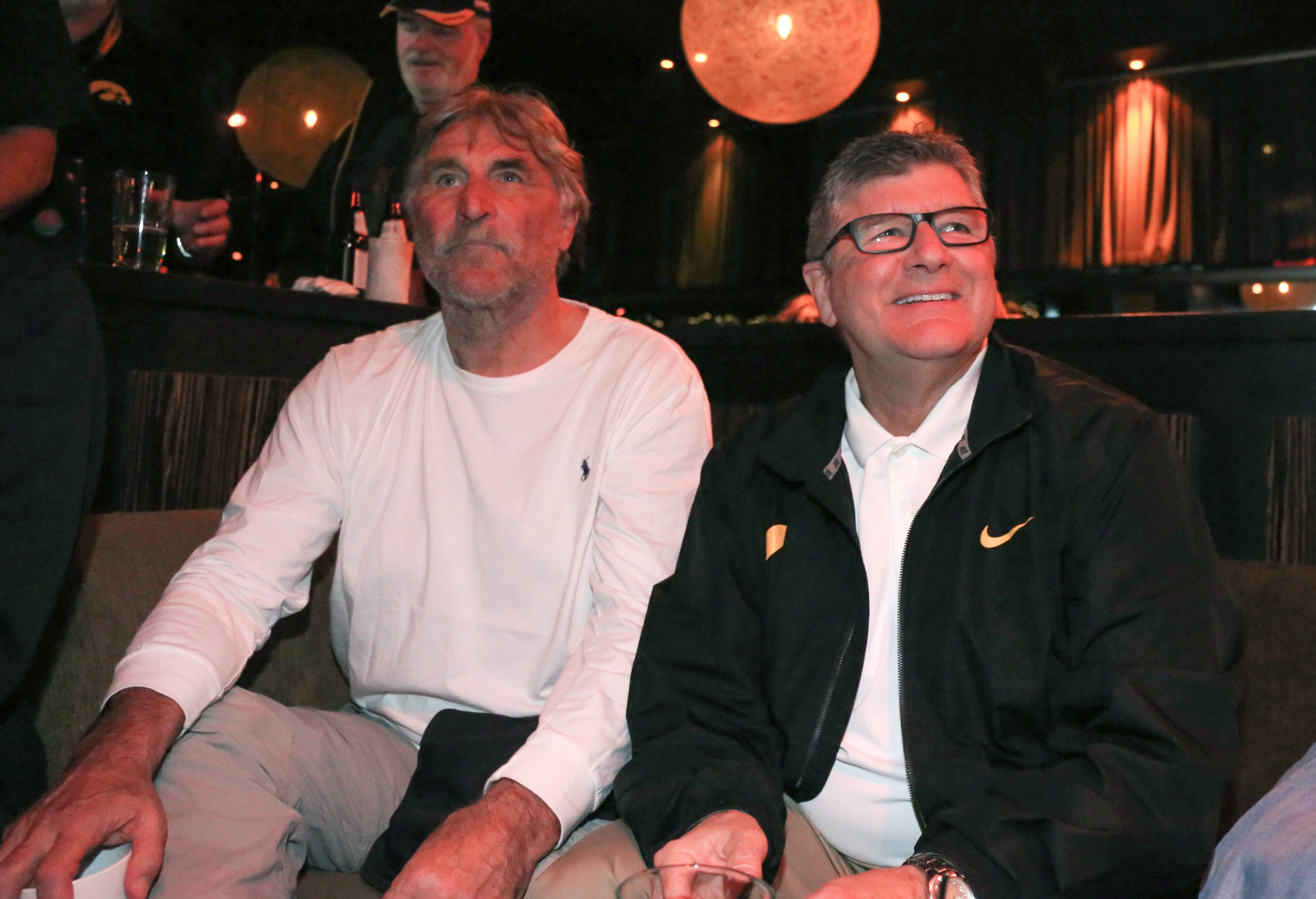 From 2015: Iowa Hawkeye broadcasters Ed Podolak, left, and Gary Dolphin watch the Iowa men's basketball team extend a lead against Michigan State from a watch party on Dec. 29, 2015, at Lucky Strike Live in Los Angeles. The Hawkeyes football team was days away from playing in the Rose Bowl, against Stanford, in Pasadena.
