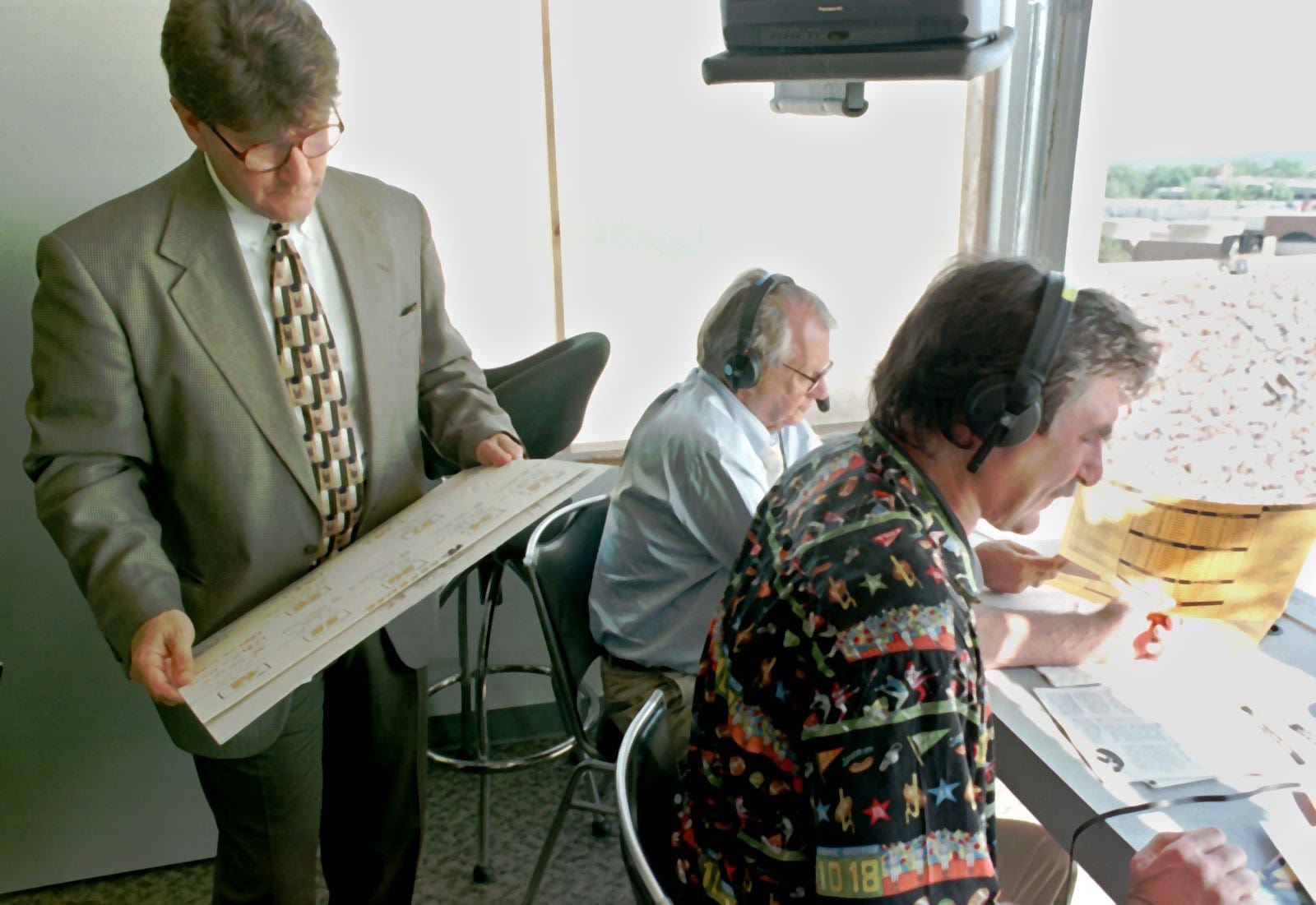 From 1997: It was Jim Zabel, background, who asked Ed Podolak, left, to become a commentator for Iowa football in 1982.