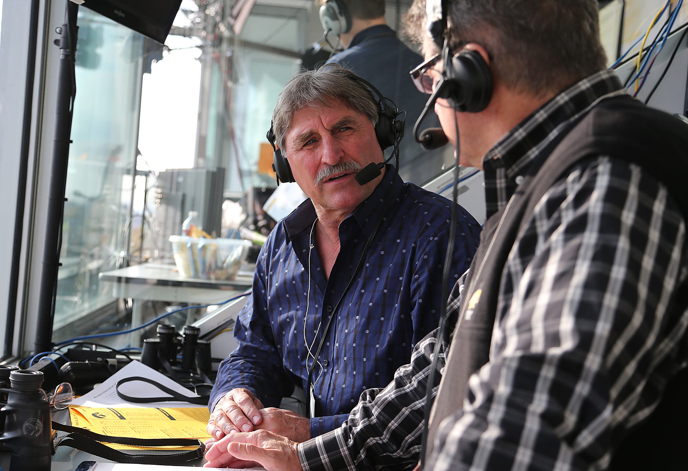 From 2013: Ed Podolak, left, talks with Iowa play-by-play announcer Gary Dolphin prior to kickoff against Wisconsin in 2013.