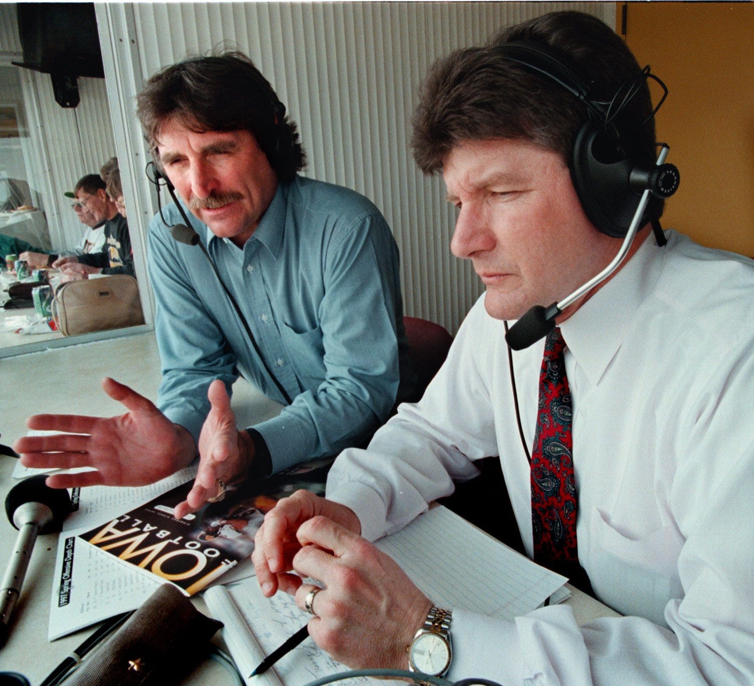 From 1997: Ed Podolak, left, works with new Iowa football play-by-play announcer Gary Dolphin before a Hawkeye spring football game.
