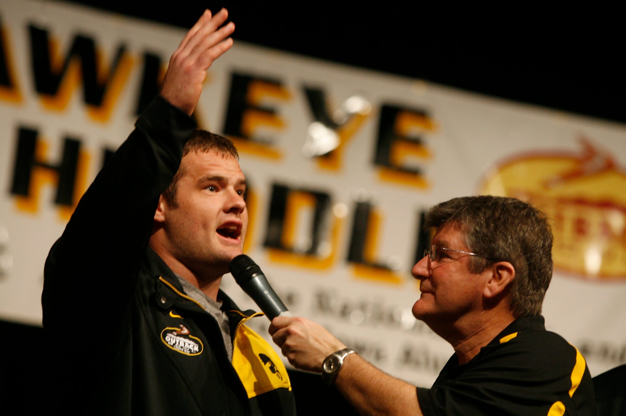 From 2008: Iowa's Matt Kroul thanks the fans while talking with Gary Dolphin during the Hawkeye Huddle  in Tampa, Fla.