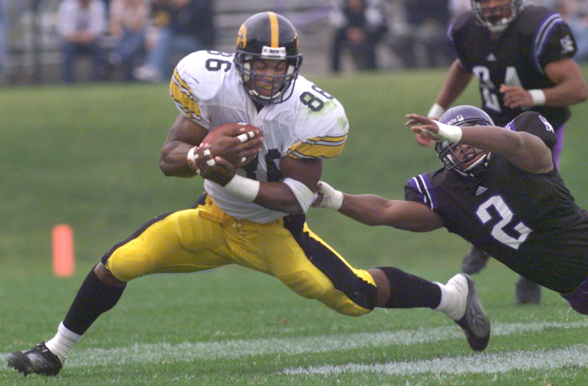 From 1999: Iowa tight end Austin Wheatley catches a pass from Randy Reiners while Kevin Bentley defends for Northwestern.