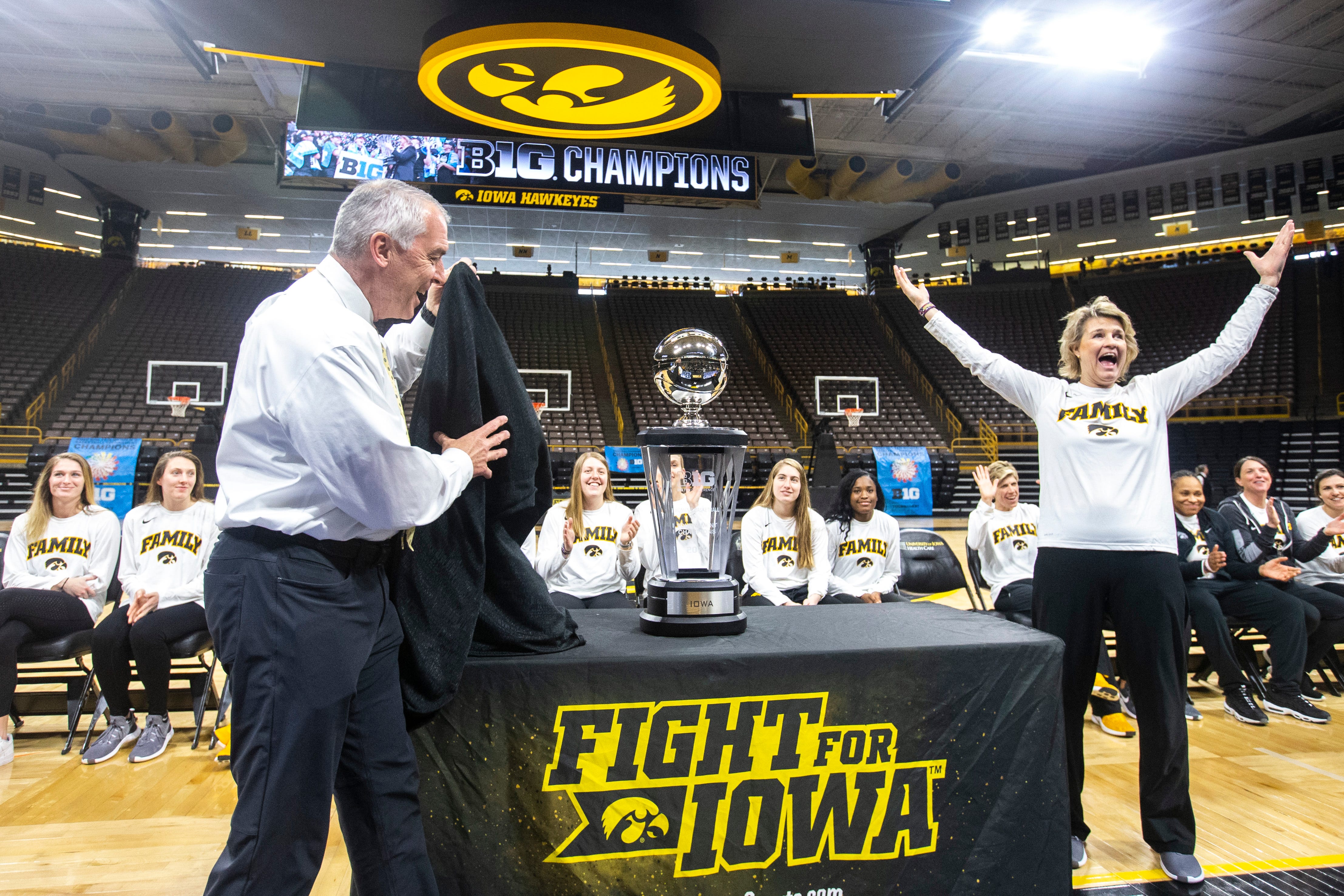 Iowa head coach Lisa Bluder, right, celebrates as Iowa athletic director Gary Barta unveils the Big Ten Tournament title during a celebration, following the NCAA selection show, on Monday, March 18, 2019, at Carver-Hawkeye Arena in Iowa City, Iowa.