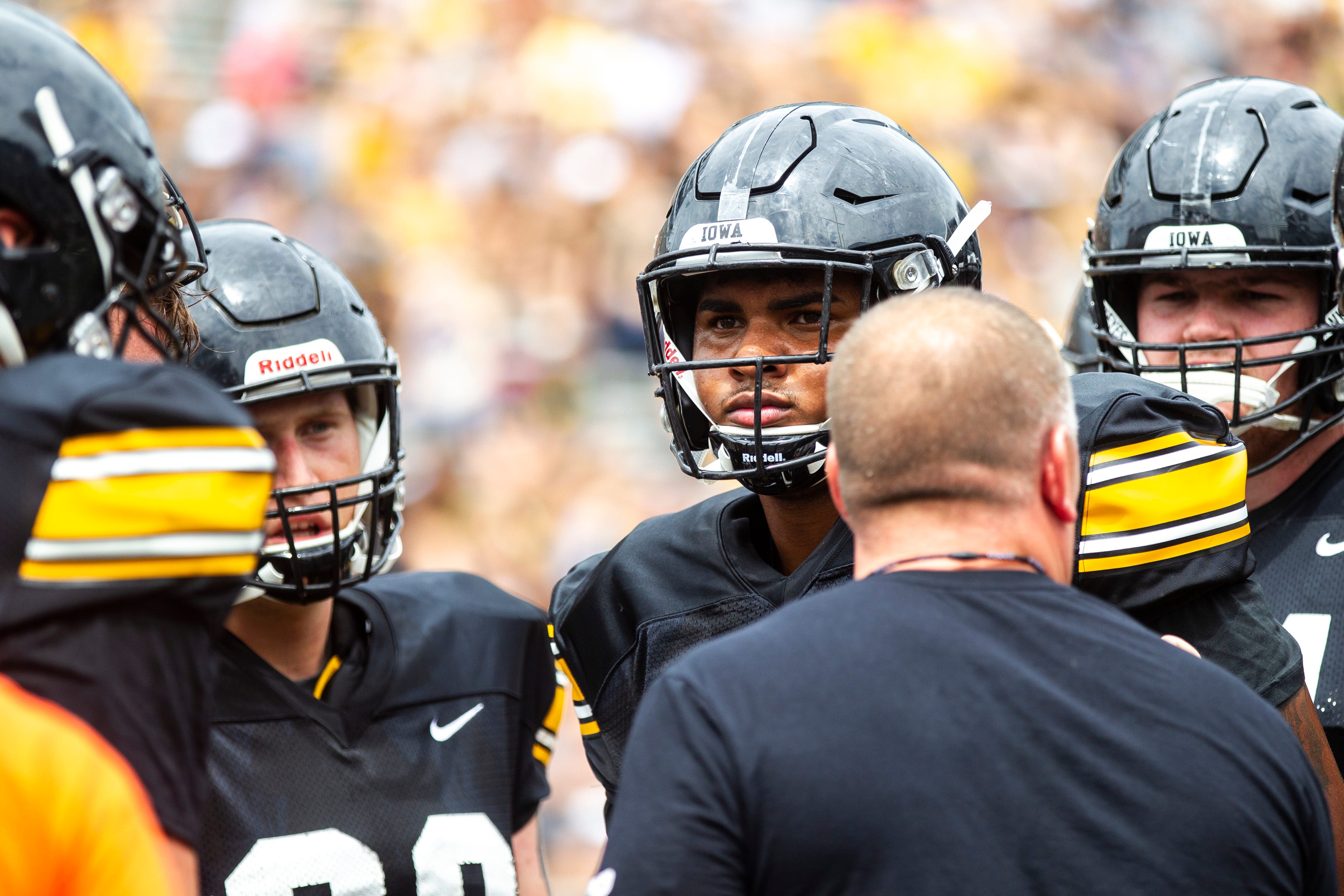 Iowa offensive linemen, including Tristan Wirfs, second from right, listen to coach Tim Polasek during a Hawkeyes football Kids Day scrimmage, Saturday, Aug. 10, 2019, at Kinnick Stadium in Iowa City, Iowa.
