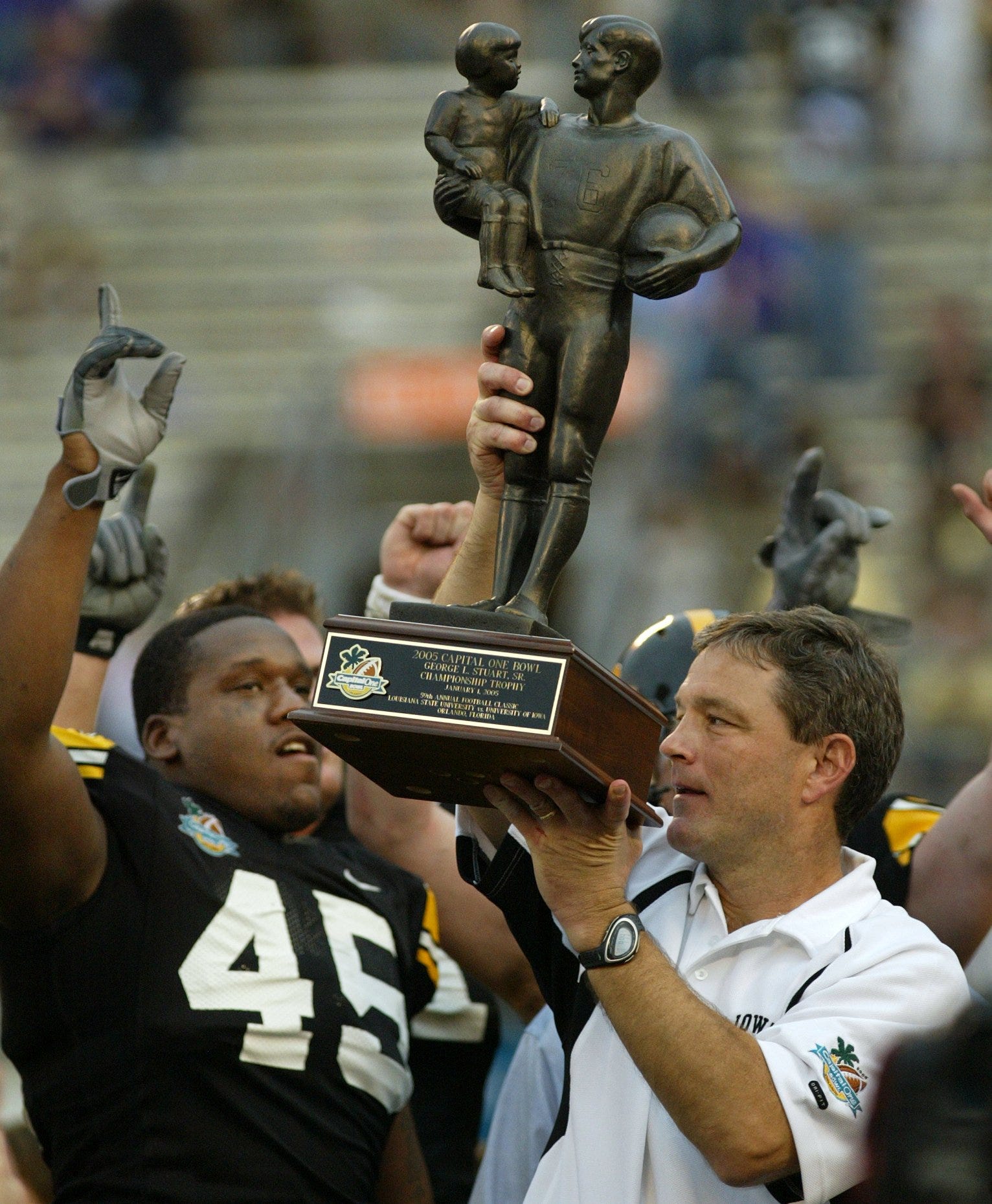 Jan. 1, 2005: Kirk Ferentz celebrates the Capital One Bowl win with Jonathan Babineaux (45) and other team members.