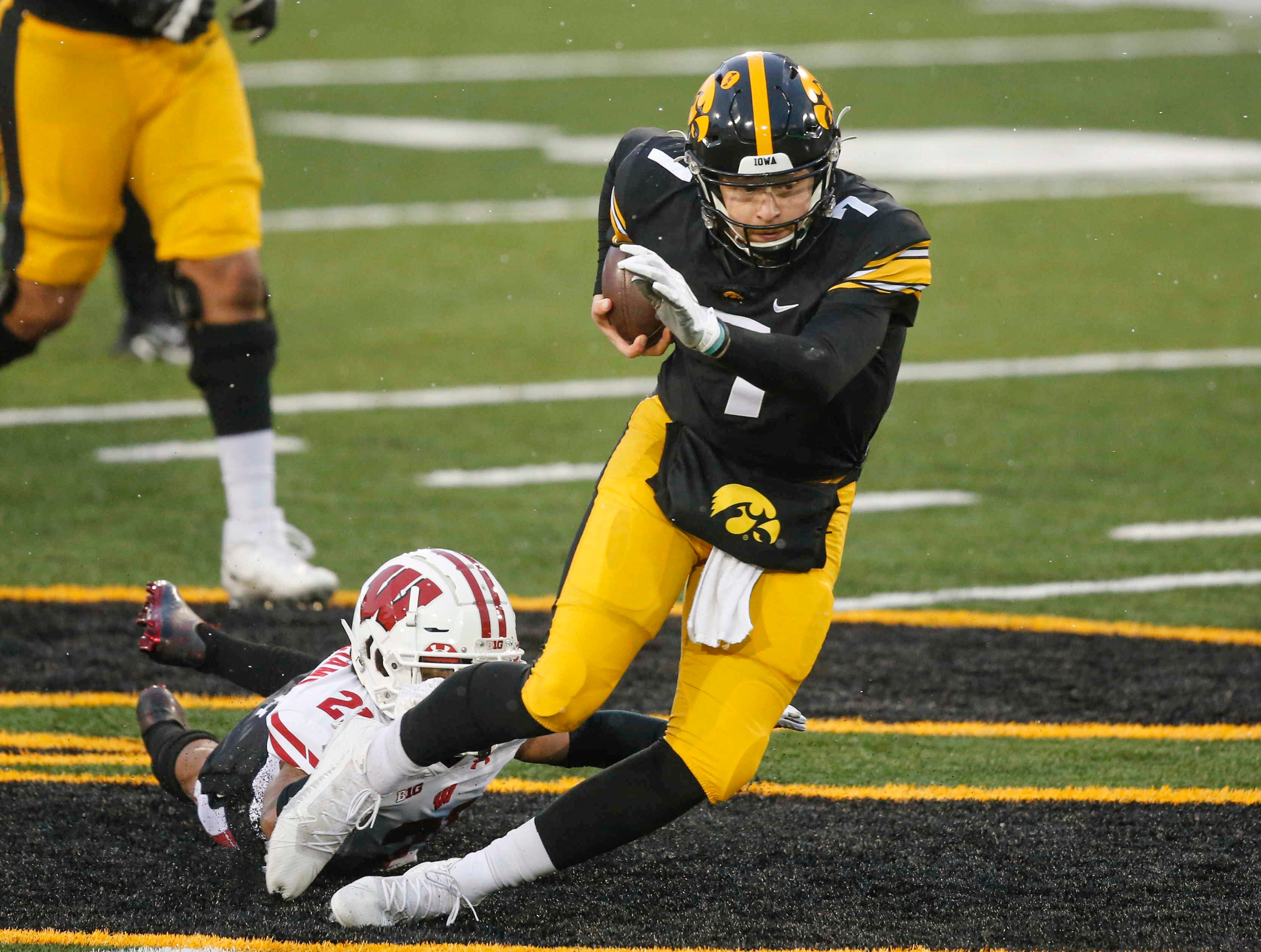 Iowa sophomore quarterback Spencer Petras scrambles for yards against Wisconsin in the second quarter on Saturday, Dec. 12, 2020, at Kinnick Stadium in Iowa City, Iowa.