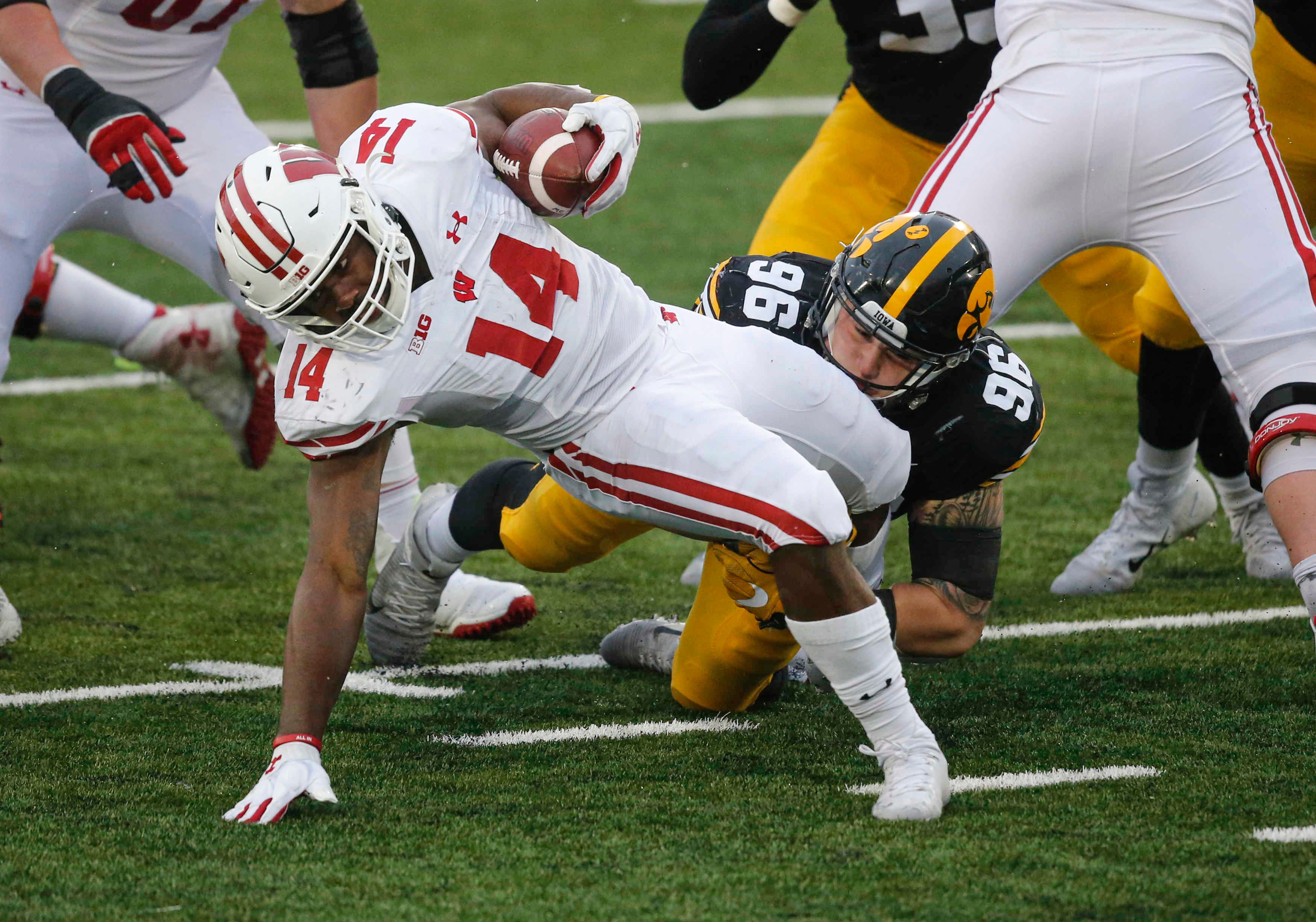 Iowa senior defensive lineman Jack Heflin tackles Wisconsin running back Nakia Watson in the backfield for a loss of yards in the second quarter on Saturday, Dec. 12, 2020, at Kinnick Stadium in Iowa City, Iowa.
