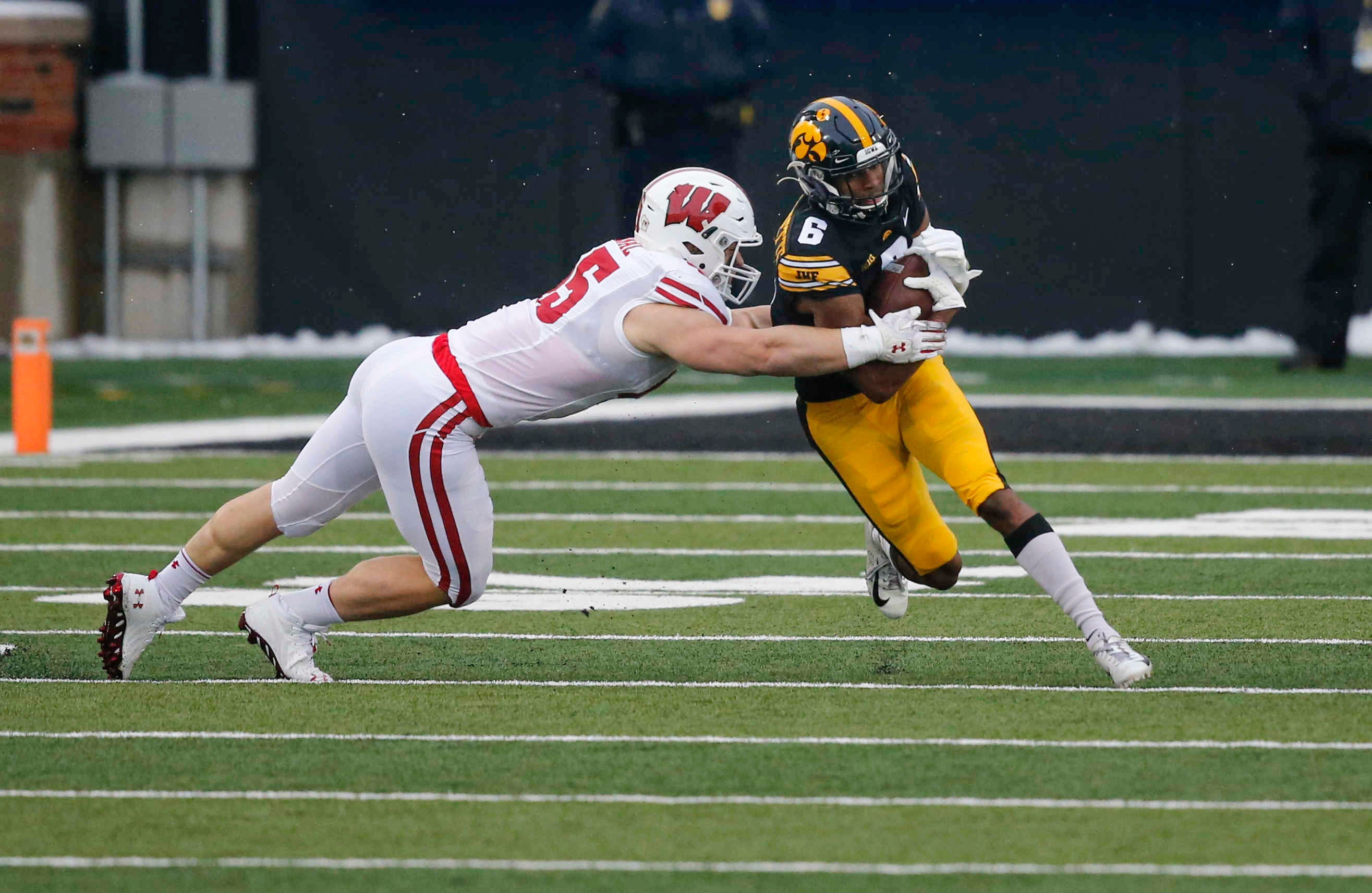 Iowa senior receiver Ihmir Smith-Marsette carries the ball for a first down in the first quarter against Wisconsin on Saturday, Dec. 12, 2020, at Kinnick Stadium in Iowa City, Iowa.