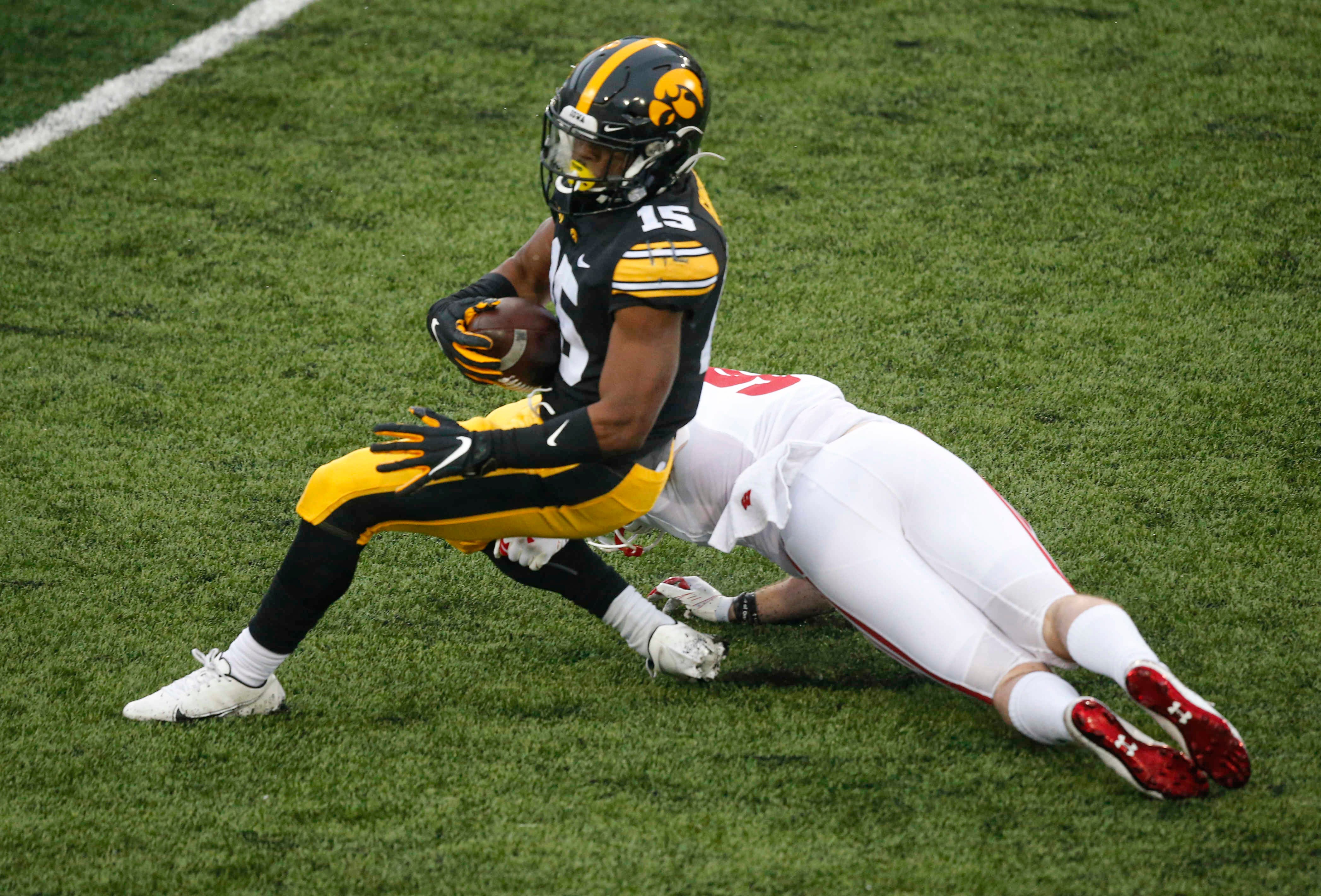 Iowa sophomore running back Tyler Goodson spins away from a tackle in the second quarter against Wisconsin on Saturday, Dec. 12, 2020, at Kinnick Stadium in Iowa City, Iowa.