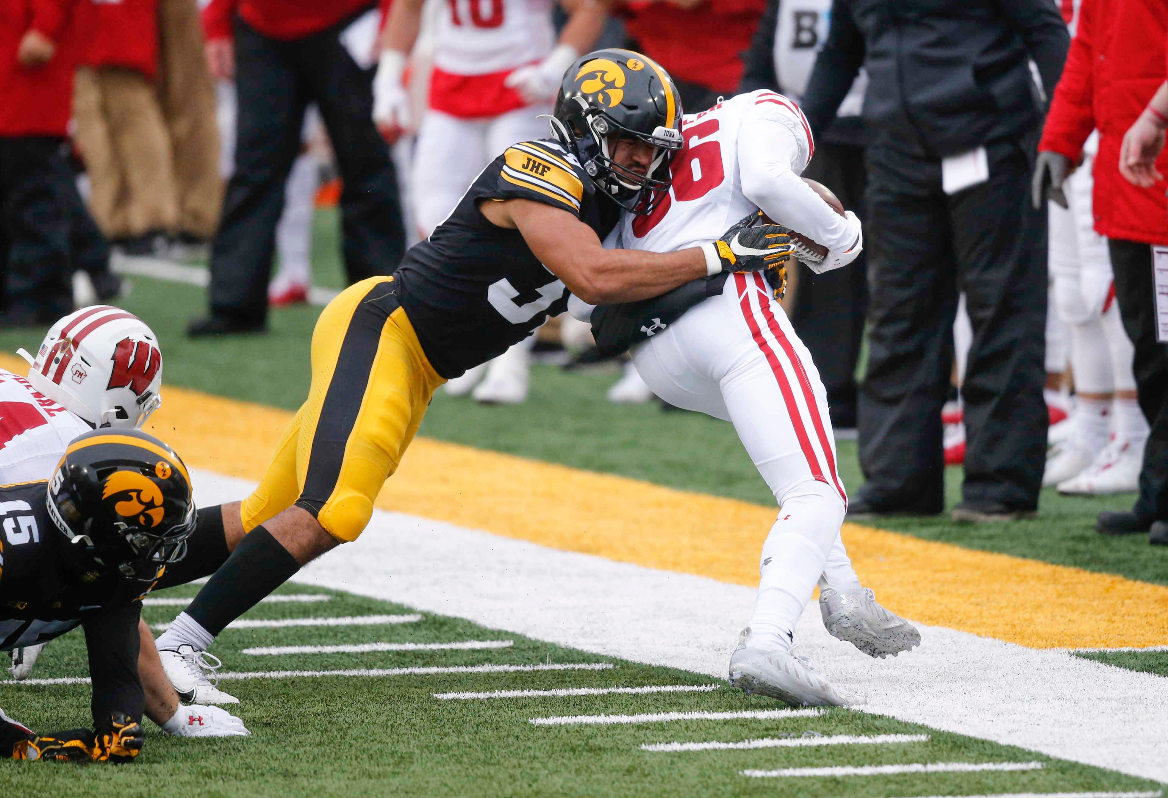 Iowa freshman defensive back Kyler Fisher hits Wisconsin' tight end Hayden Rucci out of bounds in the first quarter on Saturday, Dec. 12, 2020, at Kinnick Stadium in Iowa City, Iowa.