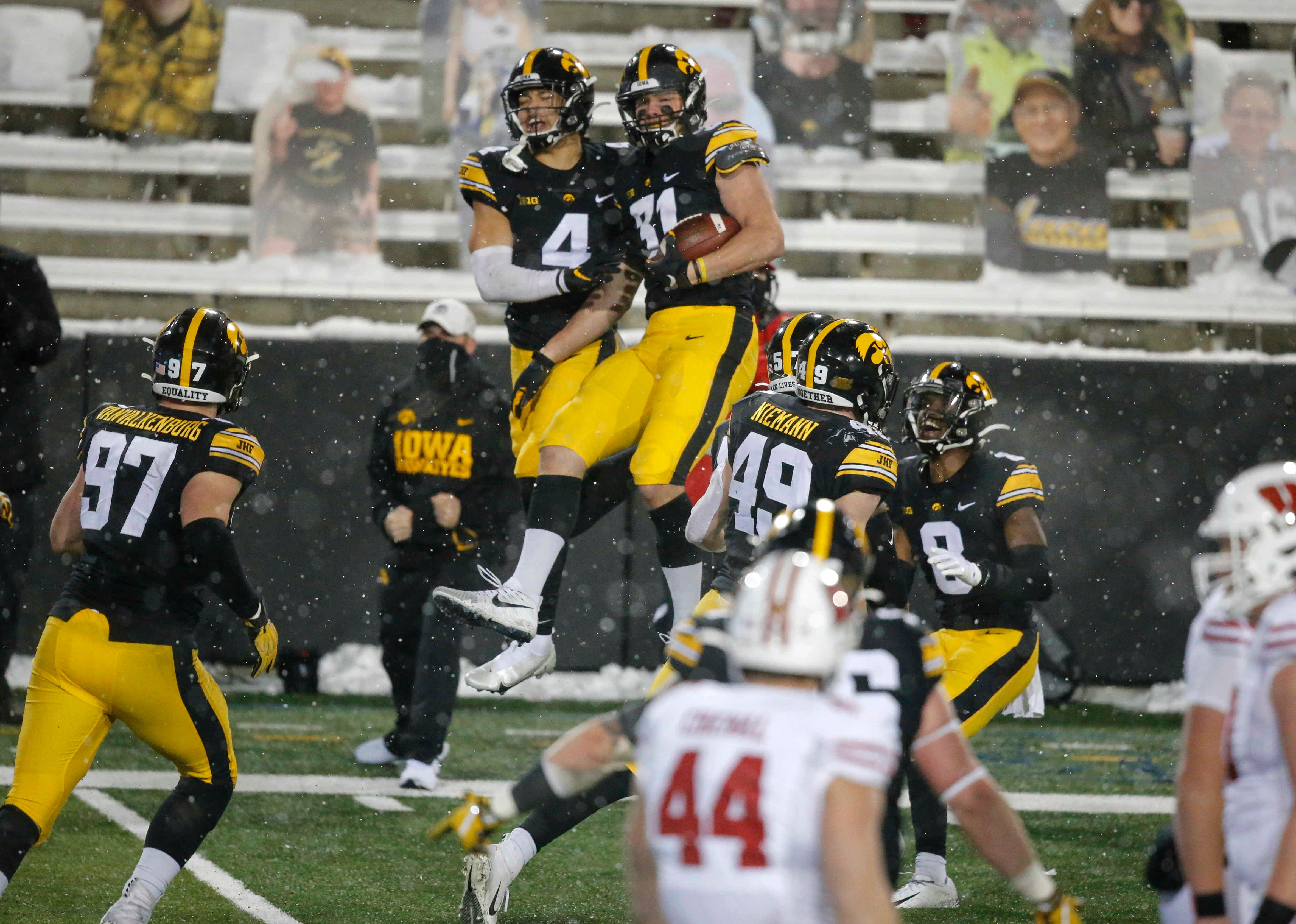 Iowa sophomore linebacker Jack Campbell, right, celebrates after coming down with an interception in the Wisconsin end zone in the fourth quarter on Saturday, Dec. 12, 2020, at Kinnick Stadium in Iowa City, Iowa.