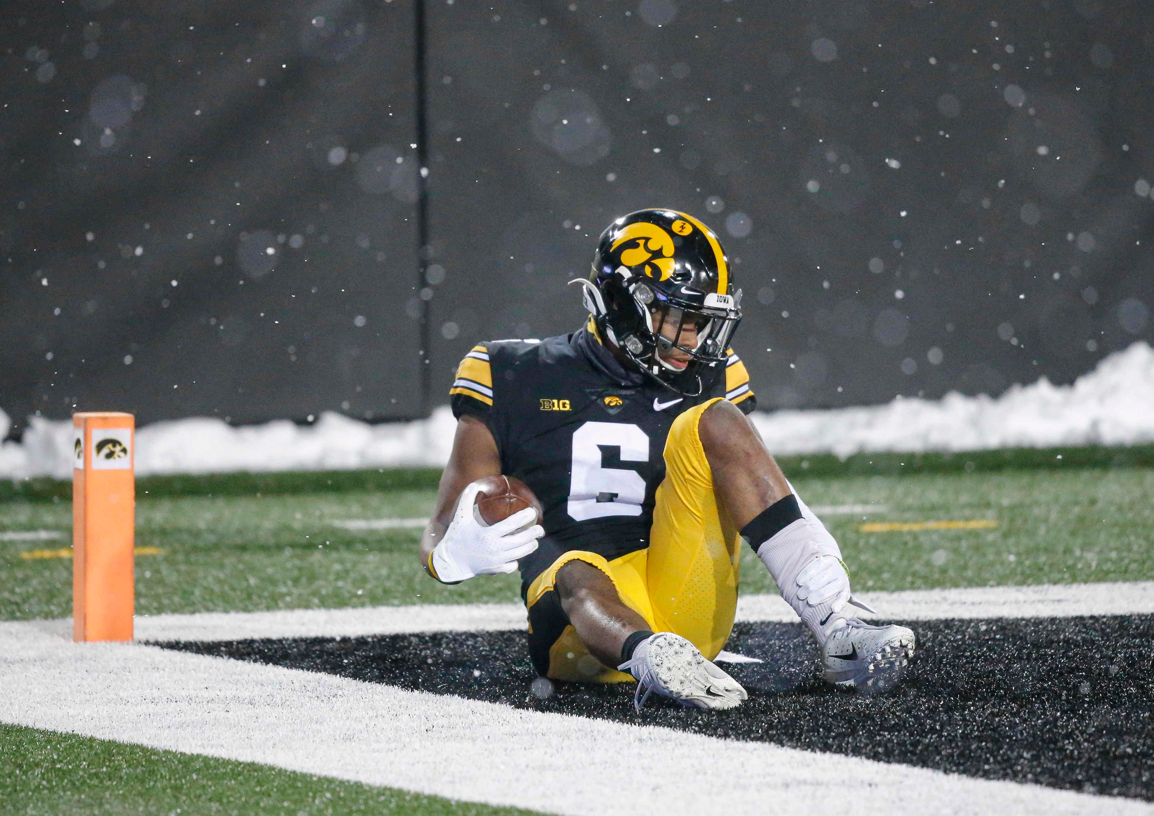 Iowa senior receiver Ihmir Smith-Marsette grabs his ankle after doing a celebratory flip in the end zone after scoring a touchdown against Wisconsin on Saturday, Dec. 12, 2020, at Kinnick Stadium in Iowa City, Iowa.