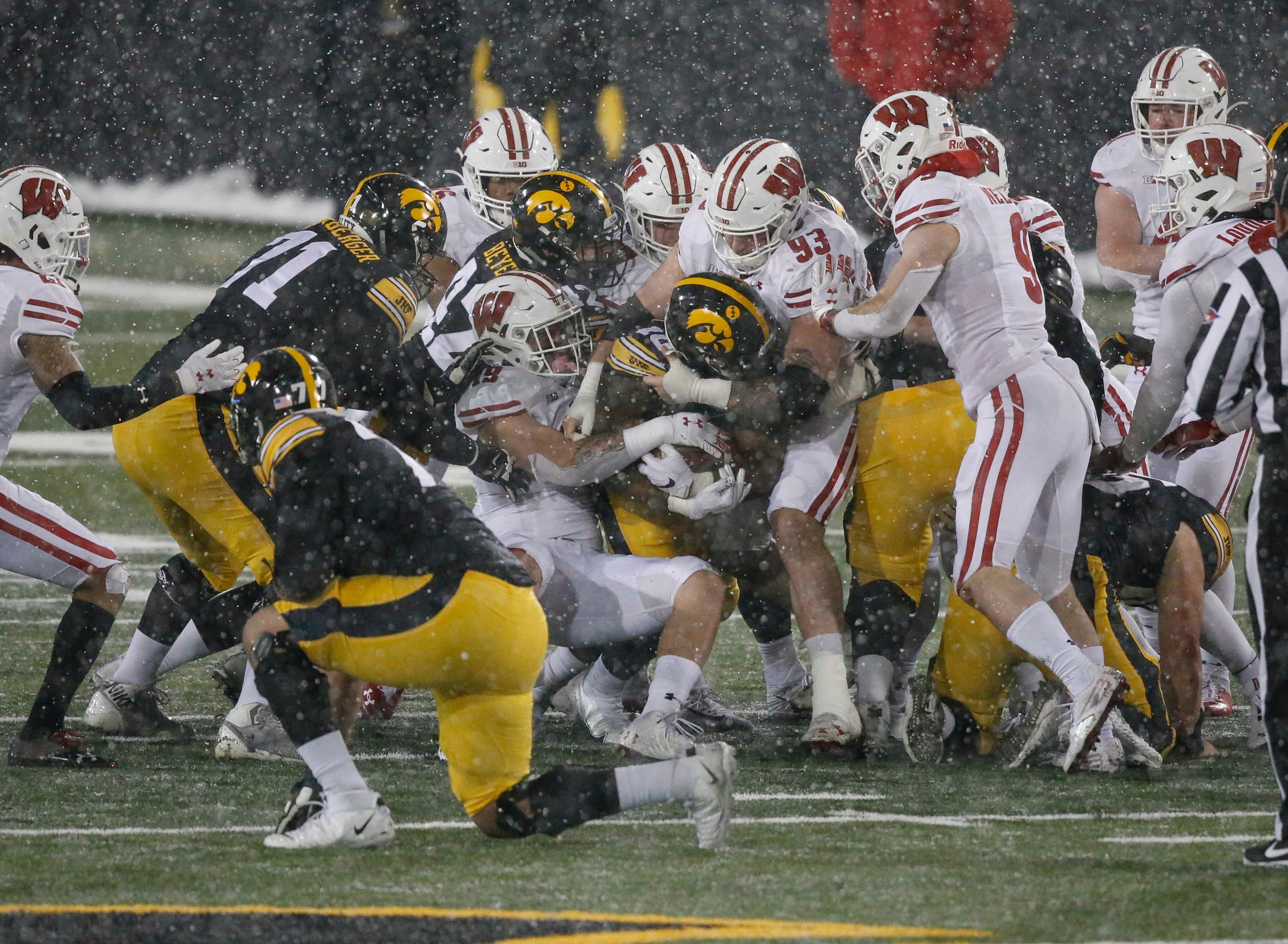 Iowa senior running back Mekhi Sargent is swallowed up by the Wisconsin defense in the fourth quarter on Saturday, Dec. 12, 2020, at Kinnick Stadium in Iowa City, Iowa.