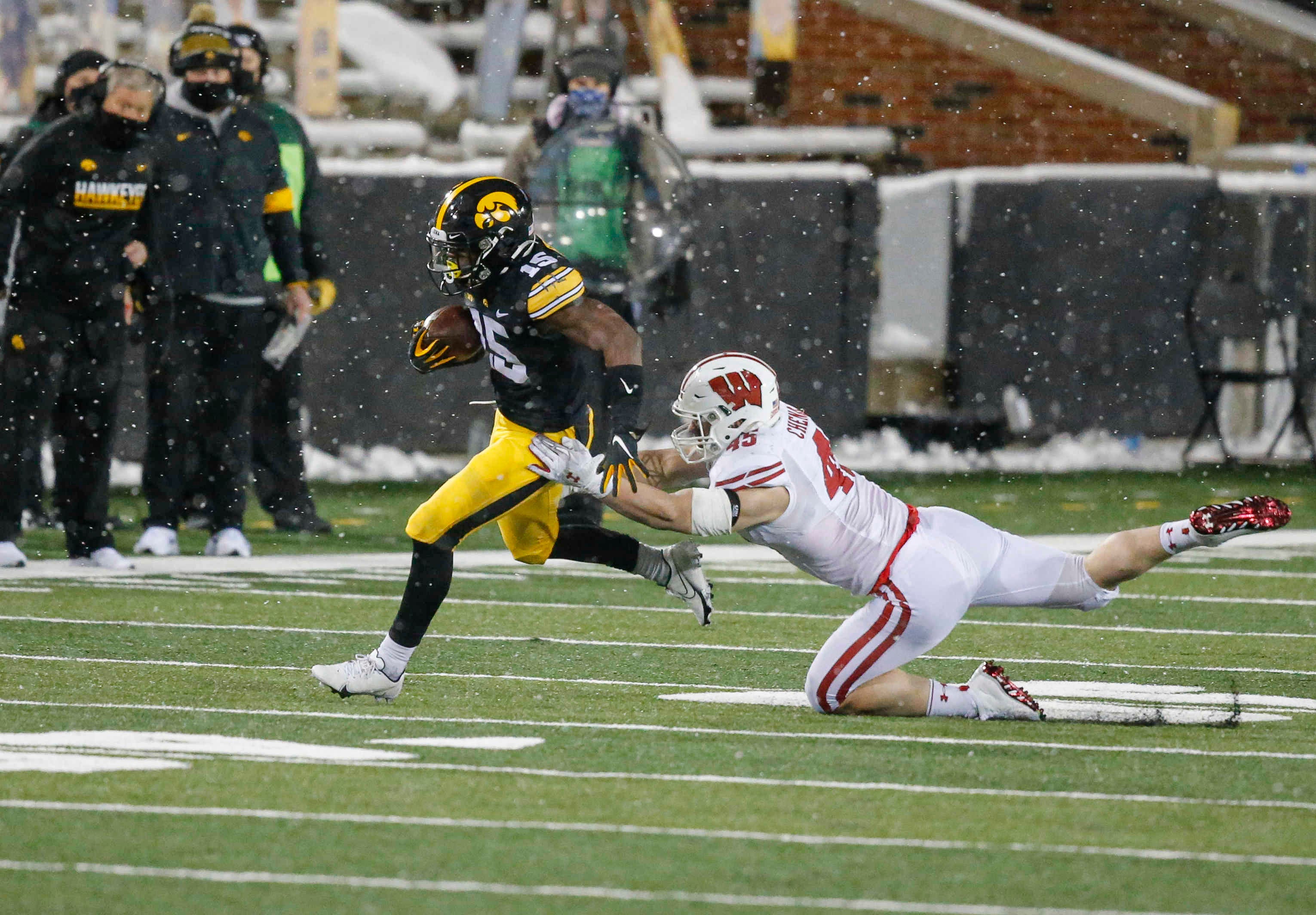 Iowa sophomore running back Tyler Goodson slips out of a Wisconsin tackle for a first down in the third quarter on Saturday, Dec. 12, 2020, at Kinnick Stadium in Iowa City, Iowa.