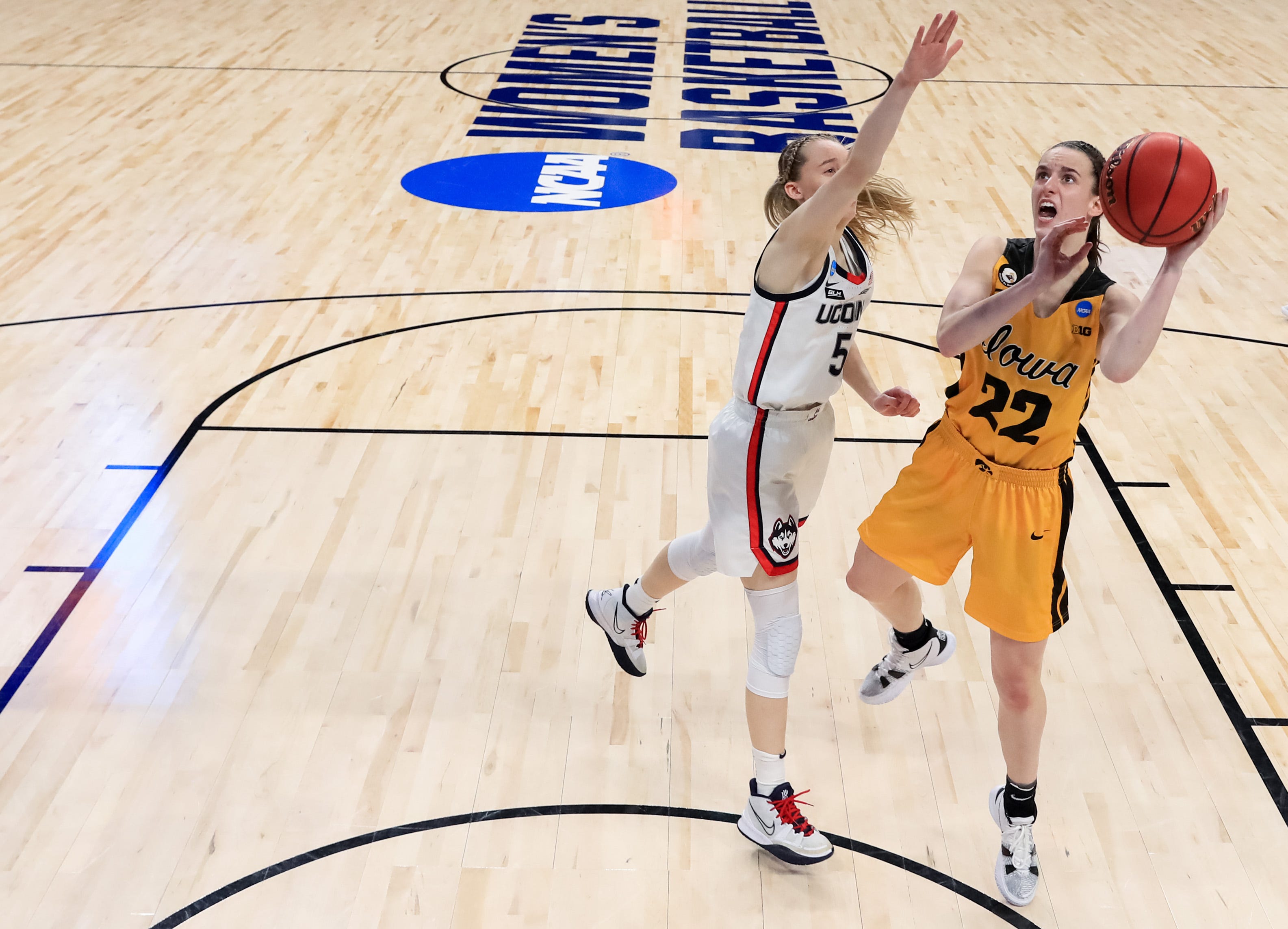 Iowa guard Caitlin Clark (22) drives to the basket against UConn's Paige Bueckers (5) during the second half in the Sweet 16 round of the NCAA Women's Basketball Tournament at the Alamodome on March 27, 2021 in San Antonio, Texas.
