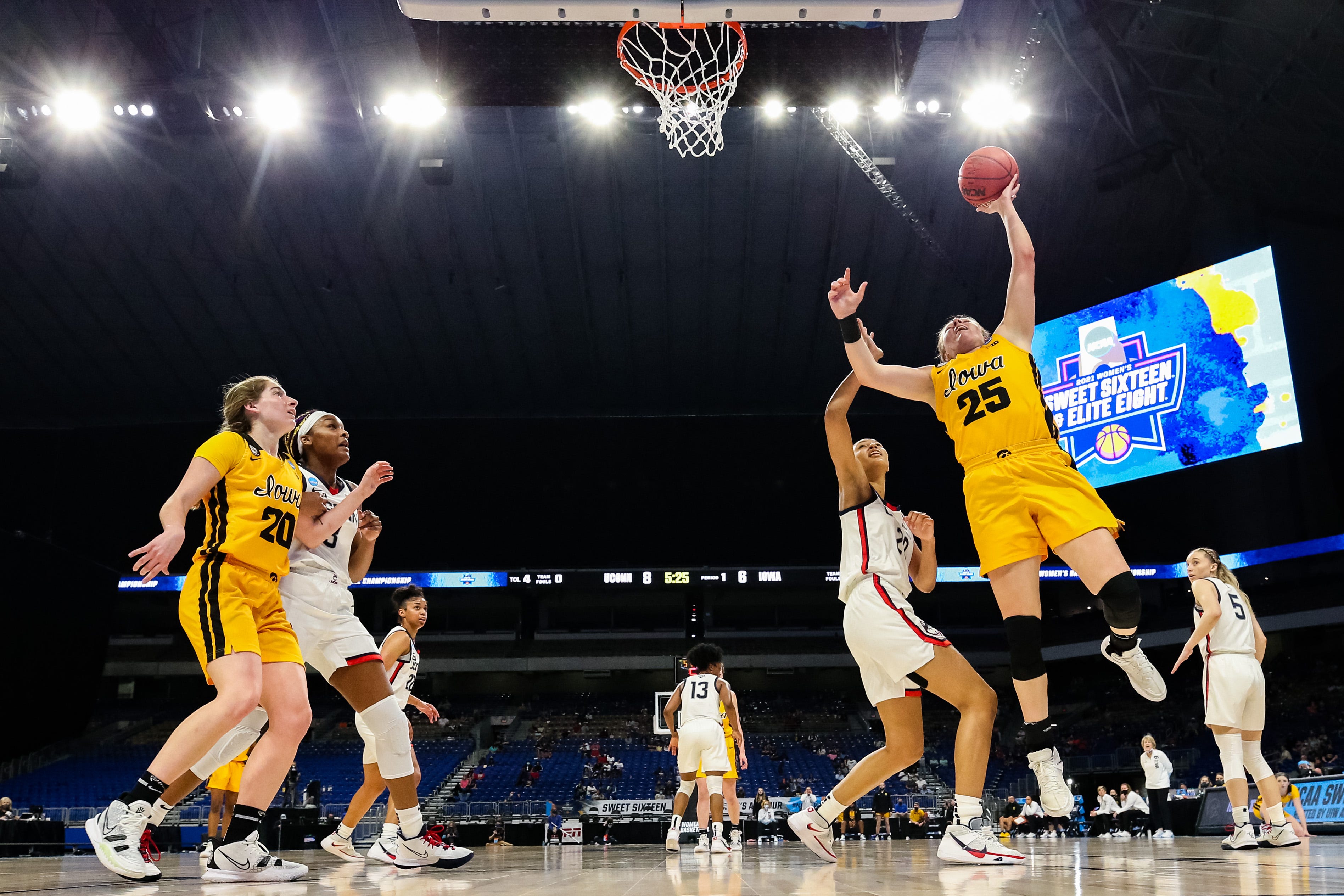 Iowa center Monika Czinano (25) drives to the basket against UConn's Olivia Nelson-Ododa (20) during the first half in the Sweet 16 round of the NCAA Women's Basketball Tournament at the Alamodome on March 27, 2021 in San Antonio, Texas.