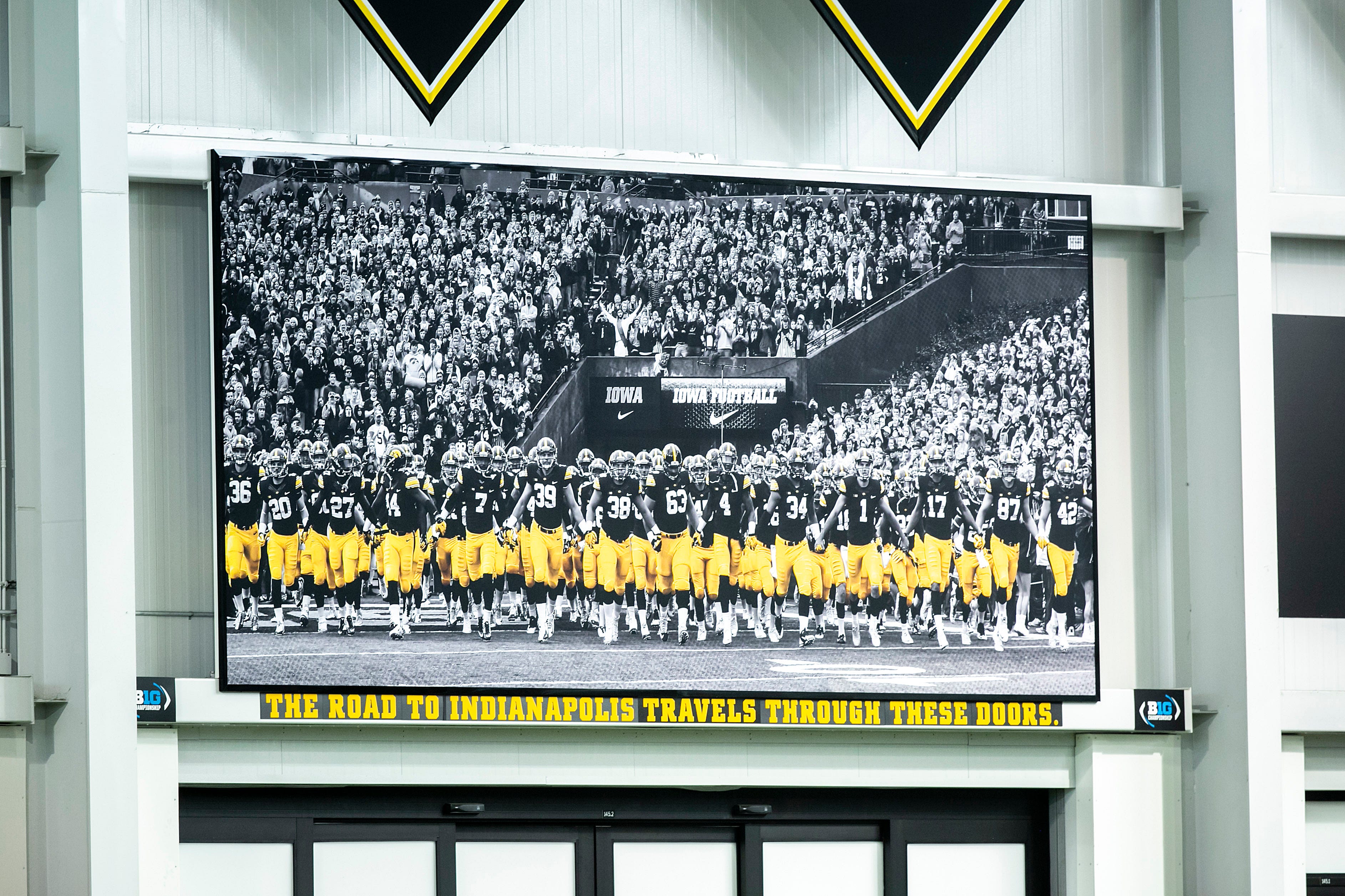A sign reading "The road to Indianapolis travels through these doors." is seen above an entrance to the Iowa Hawkeyes' weight room, Tuesday, Nov. 30, 2021, at the Hansen Football Performance Center in Iowa City, Iowa.