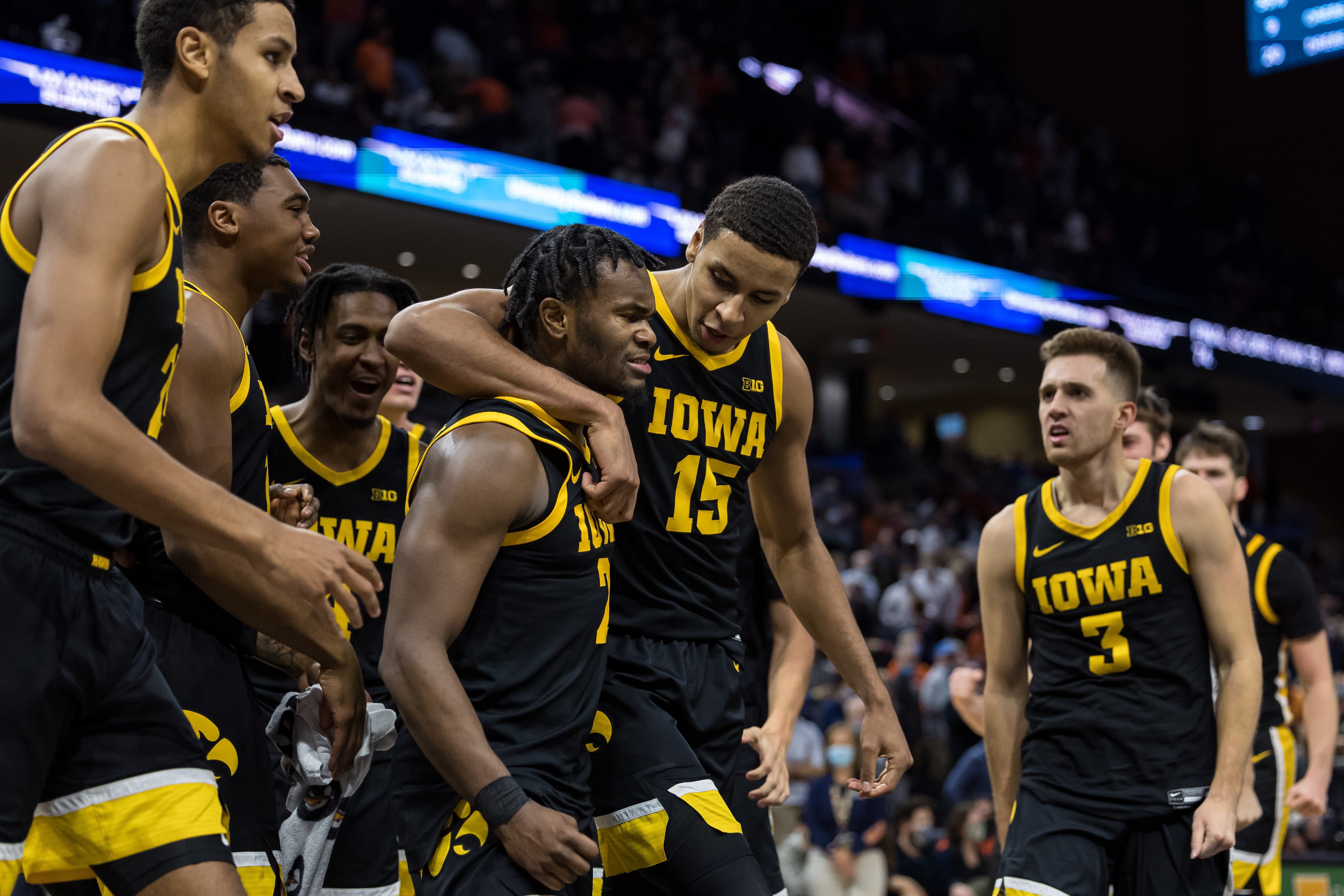 Iowa Hawkeyes guard Joe Toussaint (2) celebrates with forward Keegan Murray (15) and teammates after the game against the Virginia Cavaliers, Monday, Nov. 29, 2021, at John Paul Jones Arena in Charlottesville, Va.