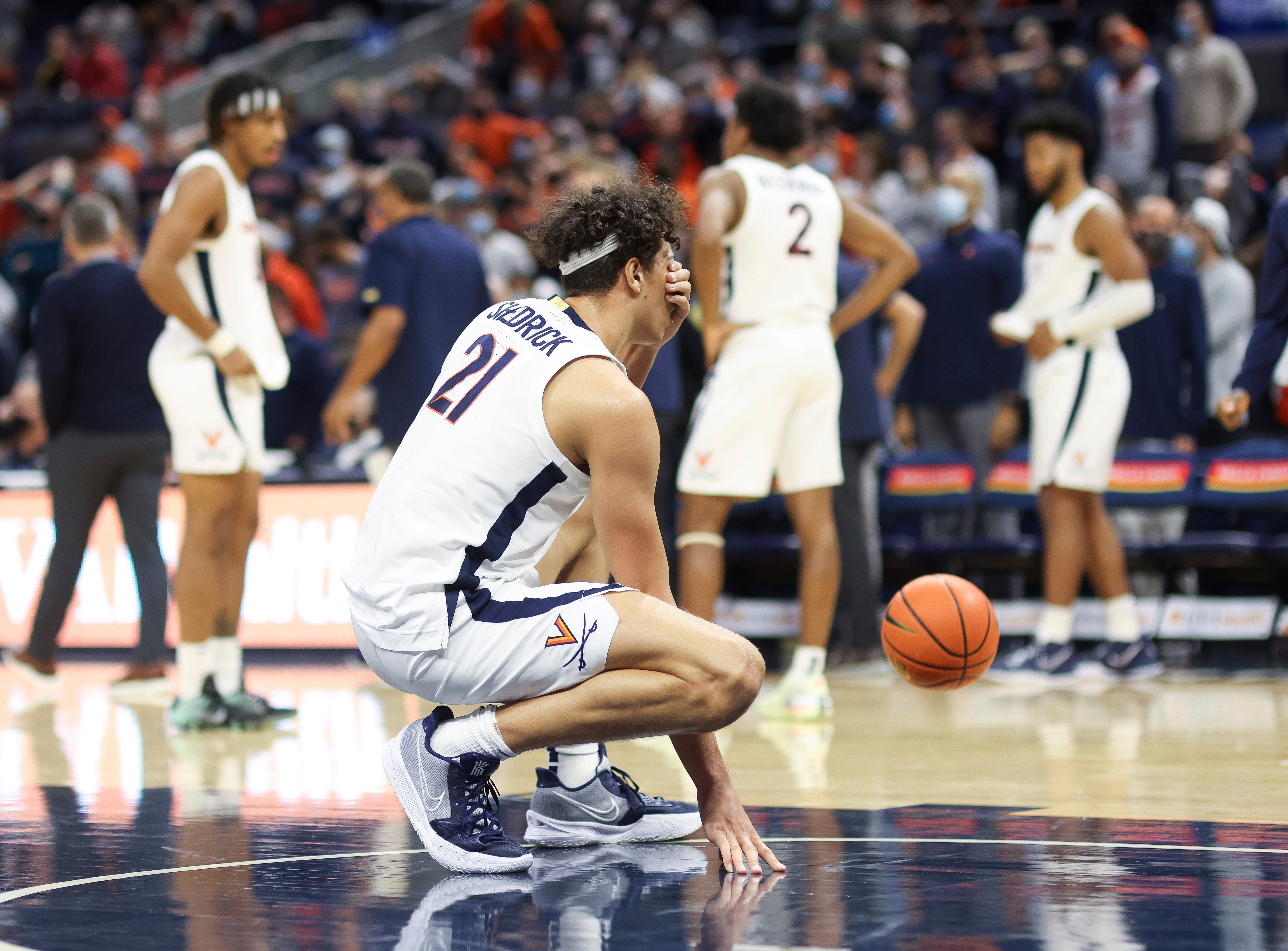 Virginia forward Kadin Shedrick (21) reacts to losing to Iowa after an NCAA college basketball game, Monday, Nov. 29, 2021, in Charlottesville, Va.