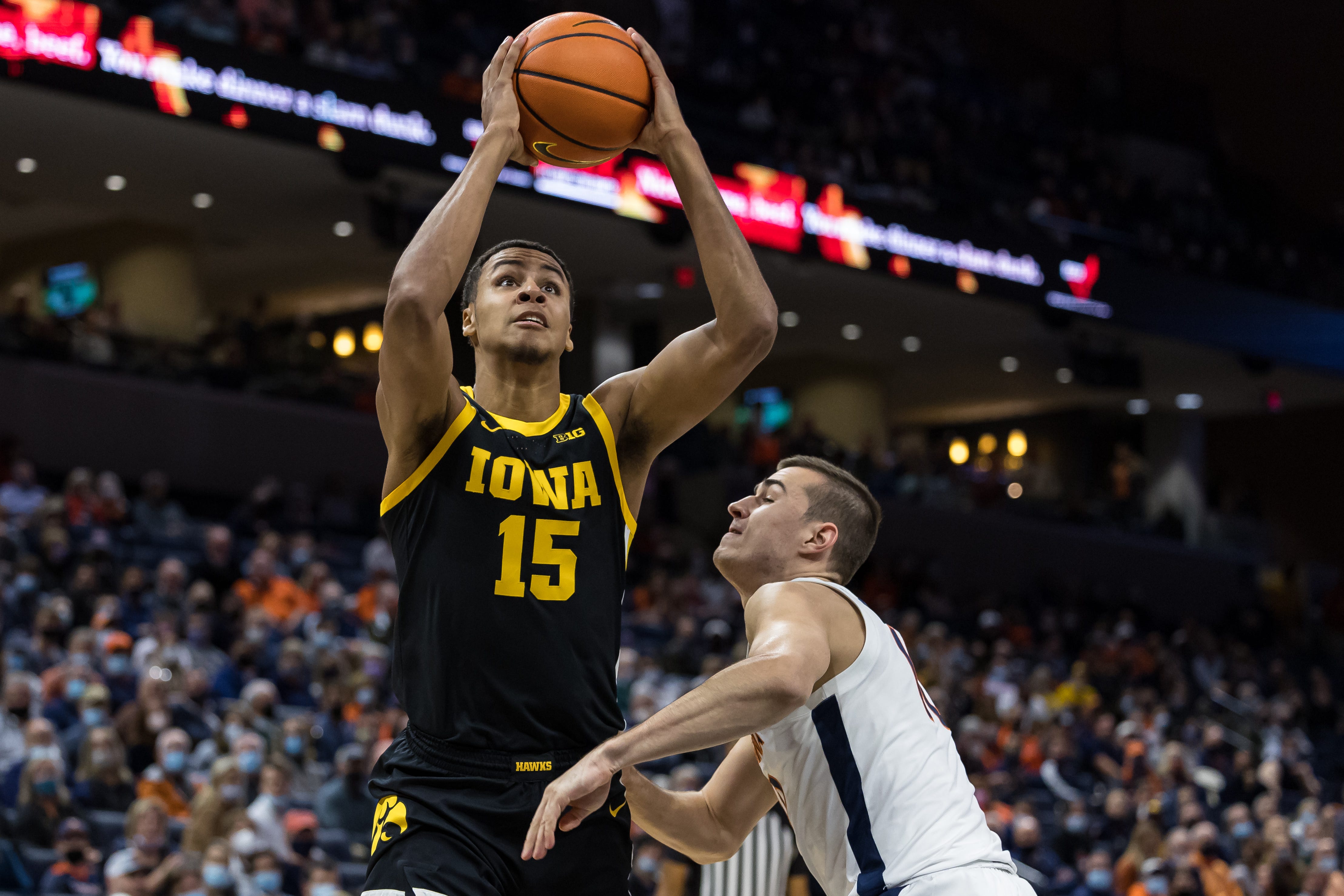 Iowa Hawkeyes forward Keegan Murray (15) goes to the basket against Virginia Cavaliers guard Taine Murray (10) during the first half, Monday, Nov. 29, 2021, at John Paul Jones Arena in Charlottesville, Va.