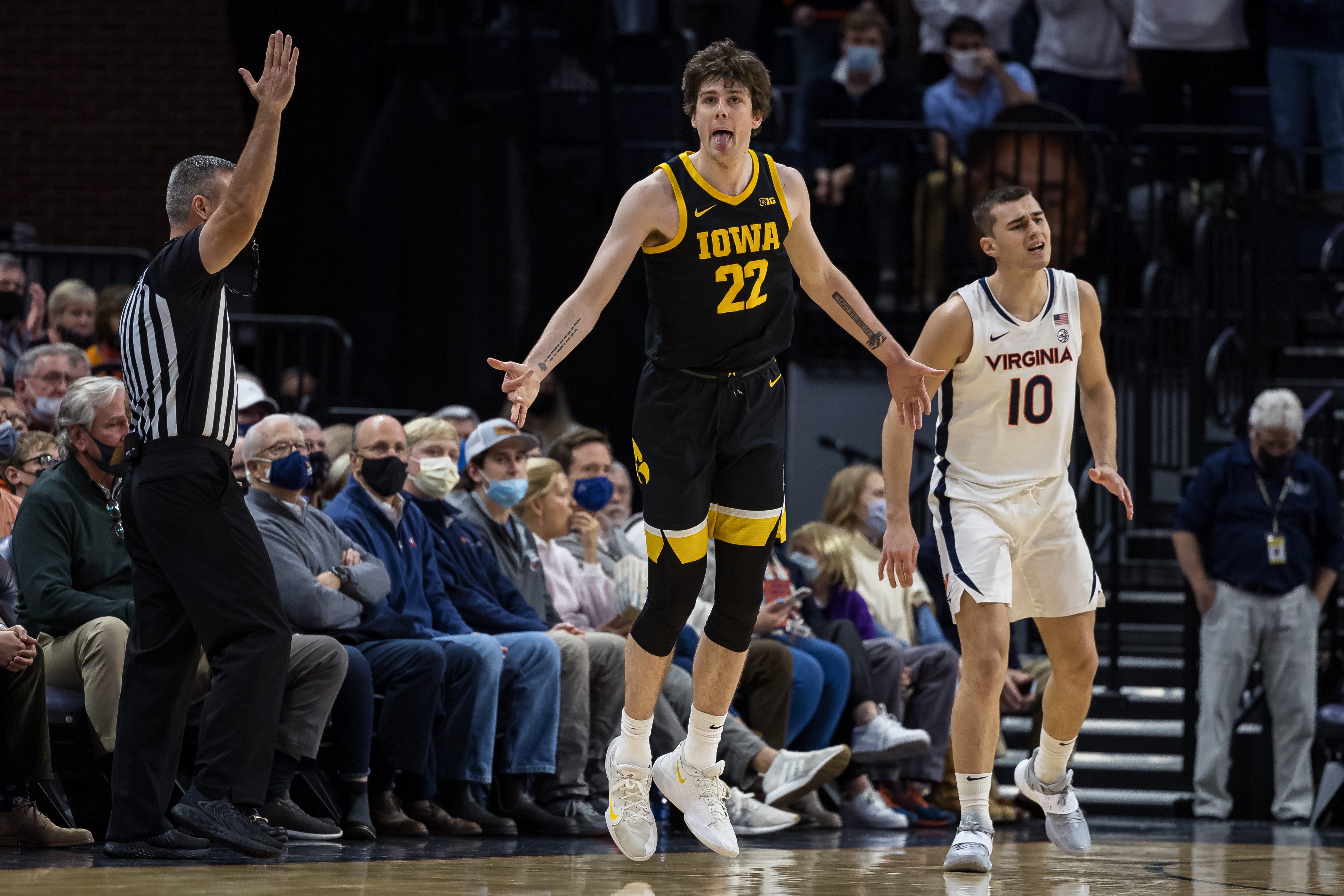 Iowa Hawkeyes forward Patrick McCaffery (22) reacts after making a three point basket in front of Virginia Cavaliers guard Taine Murray (10) during the second half, Monday, Nov. 29, 2021, at John Paul Jones Arena in Charlottesville, Va.