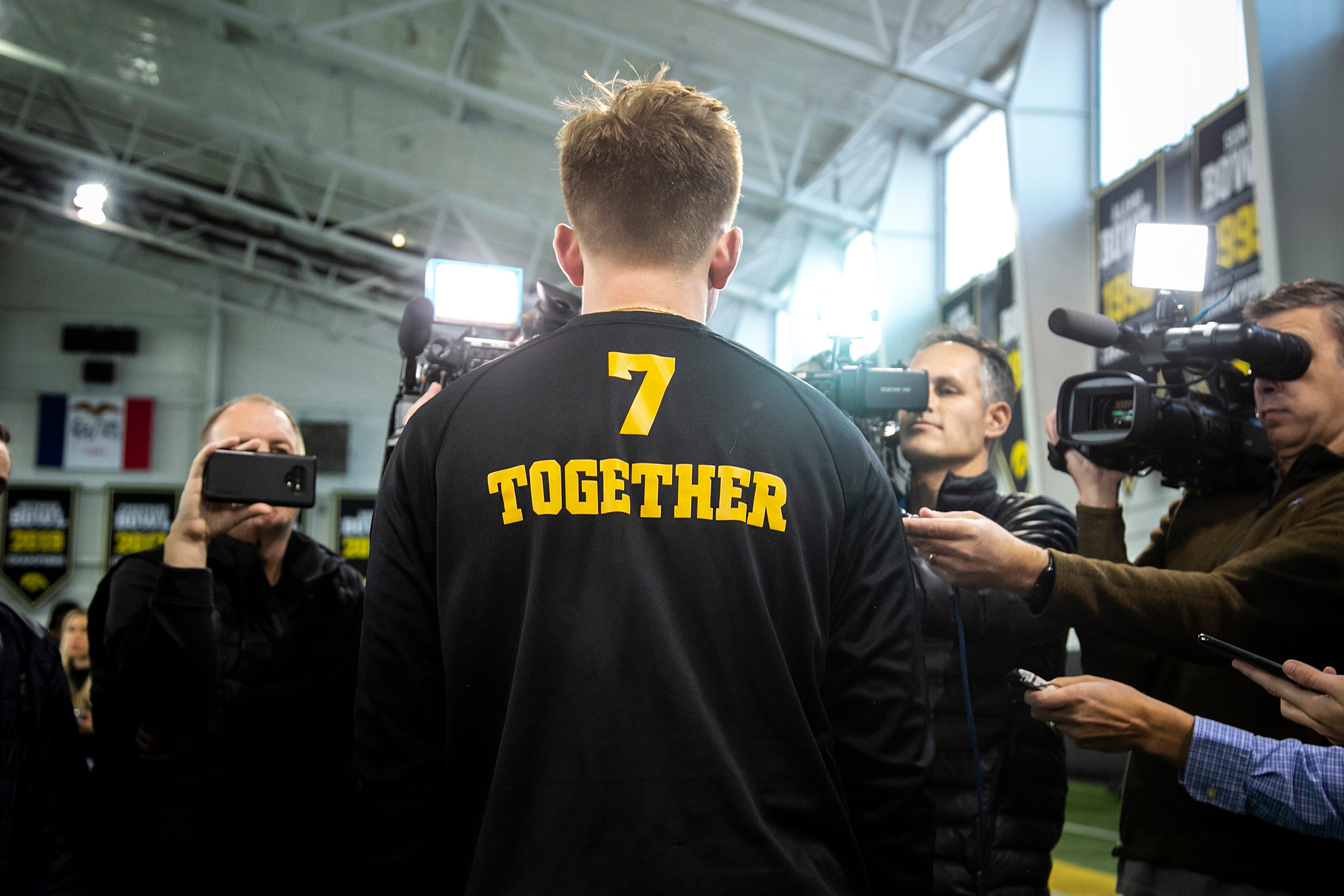Iowa quarterback Spencer Petras wears a shirt that reads "Together" as he speaks to reporters, Tuesday, Nov. 30, 2021, at the Hansen Football Performance Center in Iowa City, Iowa.