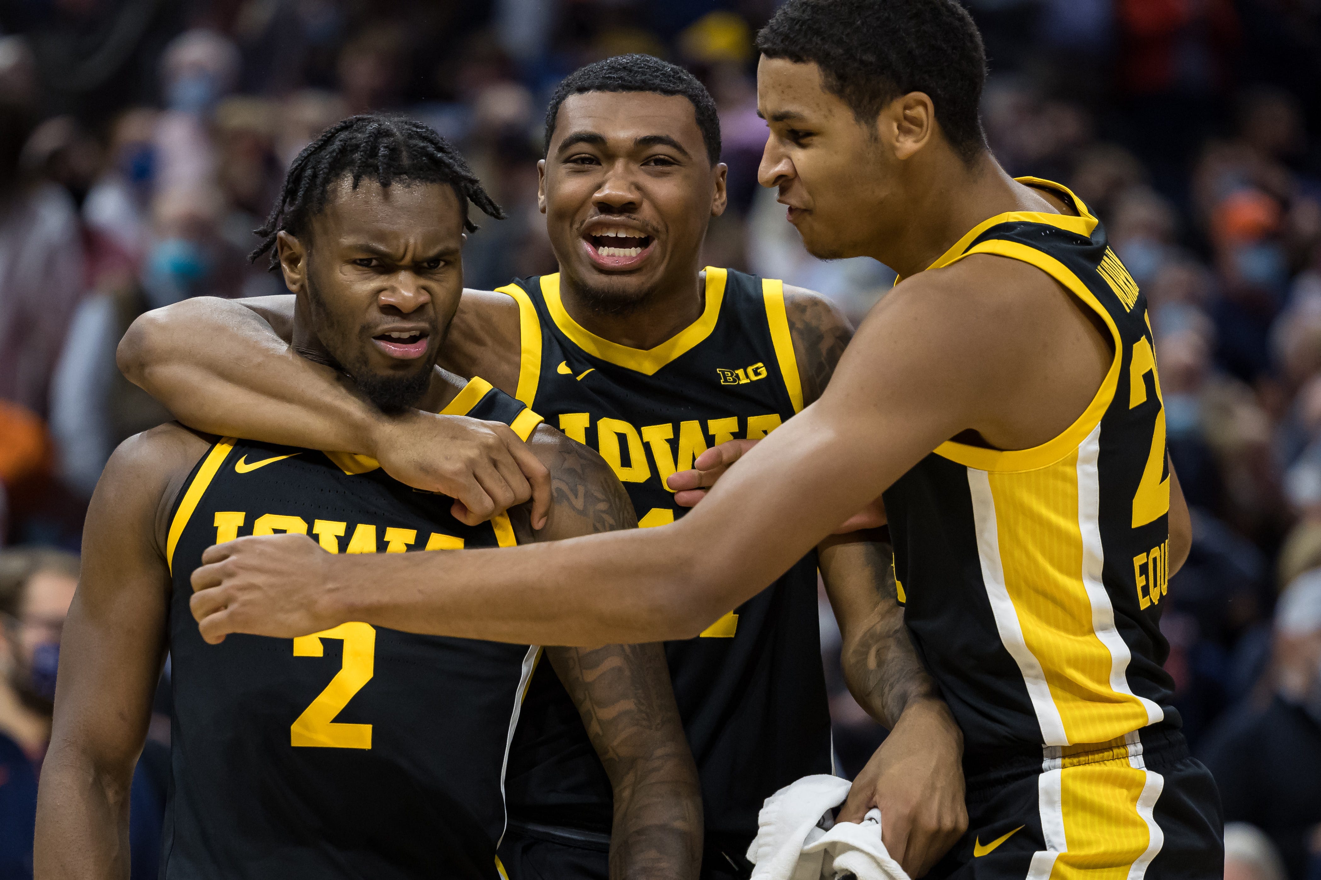Iowa Hawkeyes guard Joe Toussaint (2) celebrates with guard Tony Perkins (11) and forward Kris Murray (24) after the game against the Virginia Cavaliers, Monday, Nov. 29, 2021, at John Paul Jones Arena in Charlottesville, Va.
