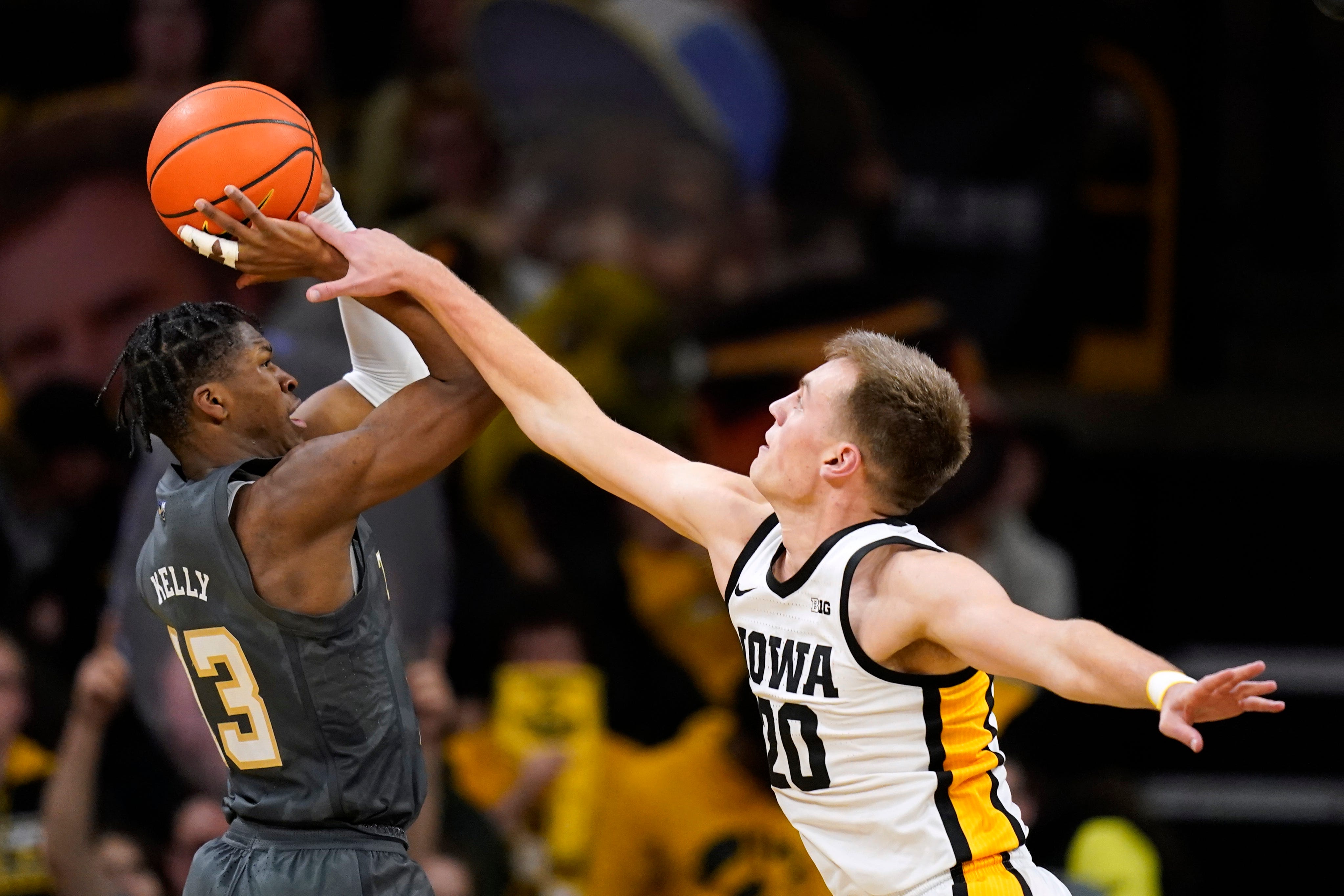 Georgia Tech guard Miles Kelly (13) is fouled by Iowa forward Payton Sandfort (20) during the second half of an NCAA college basketball game, Tuesday, Nov. 29, 2022, in Iowa City, Iowa.