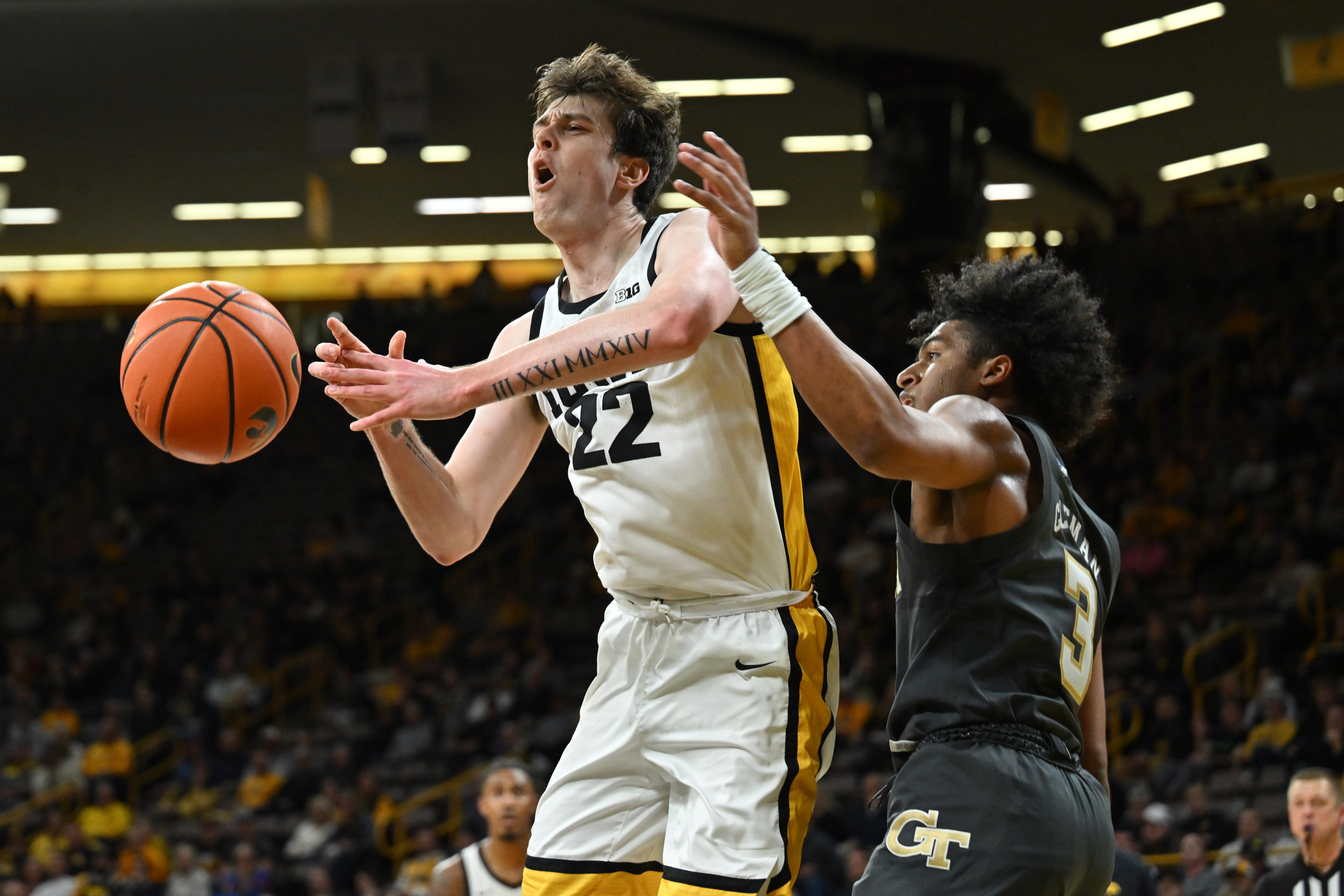 Iowa forward Patrick McCaffery (22) is defended by Georgia Tech guard Dallan Coleman (3) during the second half of an NCAA college basketball game, Tuesday, Nov. 29, 2022, in Iowa City, Iowa.