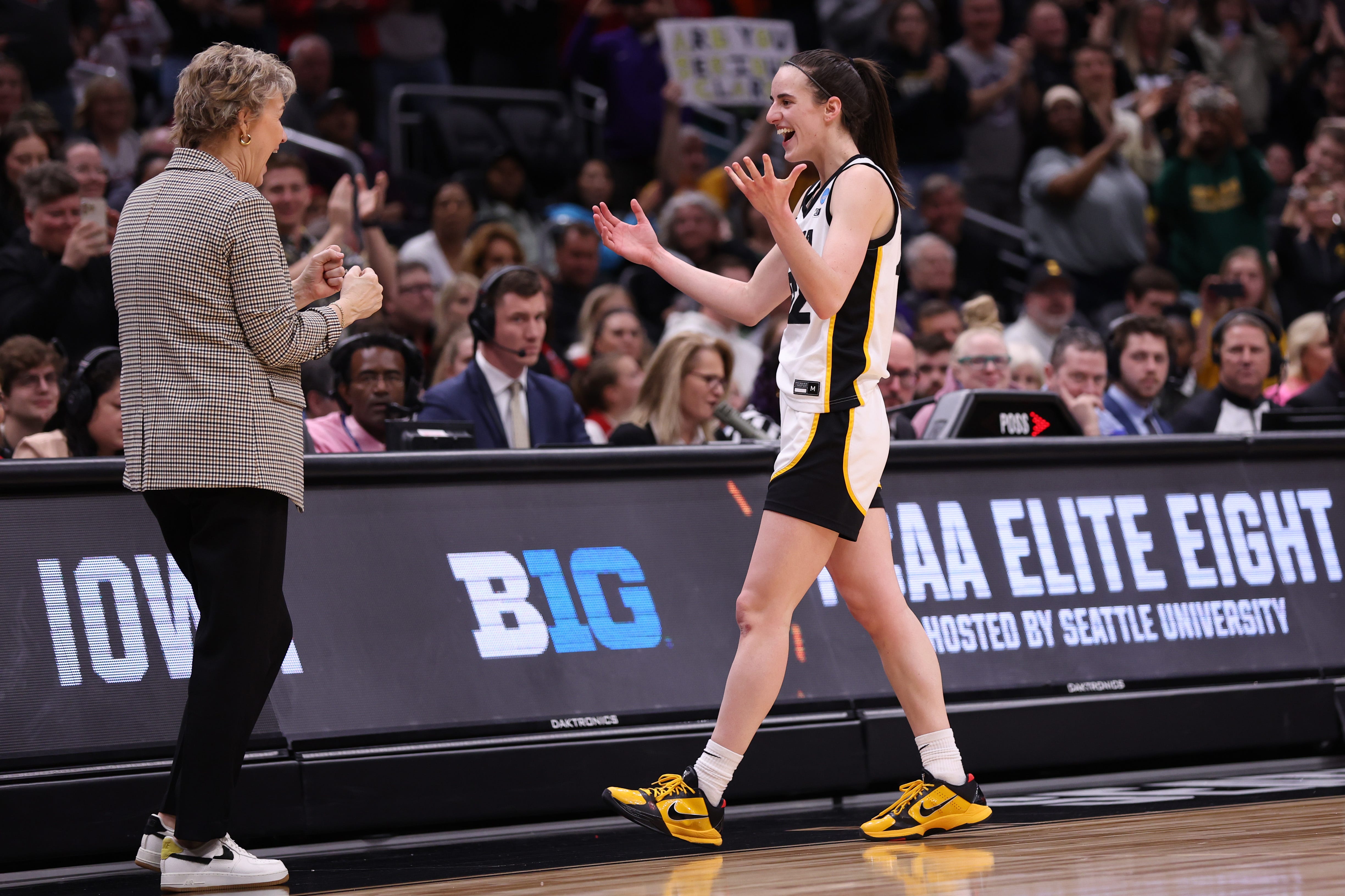 Iowa head coach Lisa Bluder, left, embraces Caitlin Clark as they celebrate after defeating the Louisville Cardinals in the Elite Eight round of the NCAA Women's Basketball Tournament, March 26, 2023, at Climate Pledge Arena in Seattle.