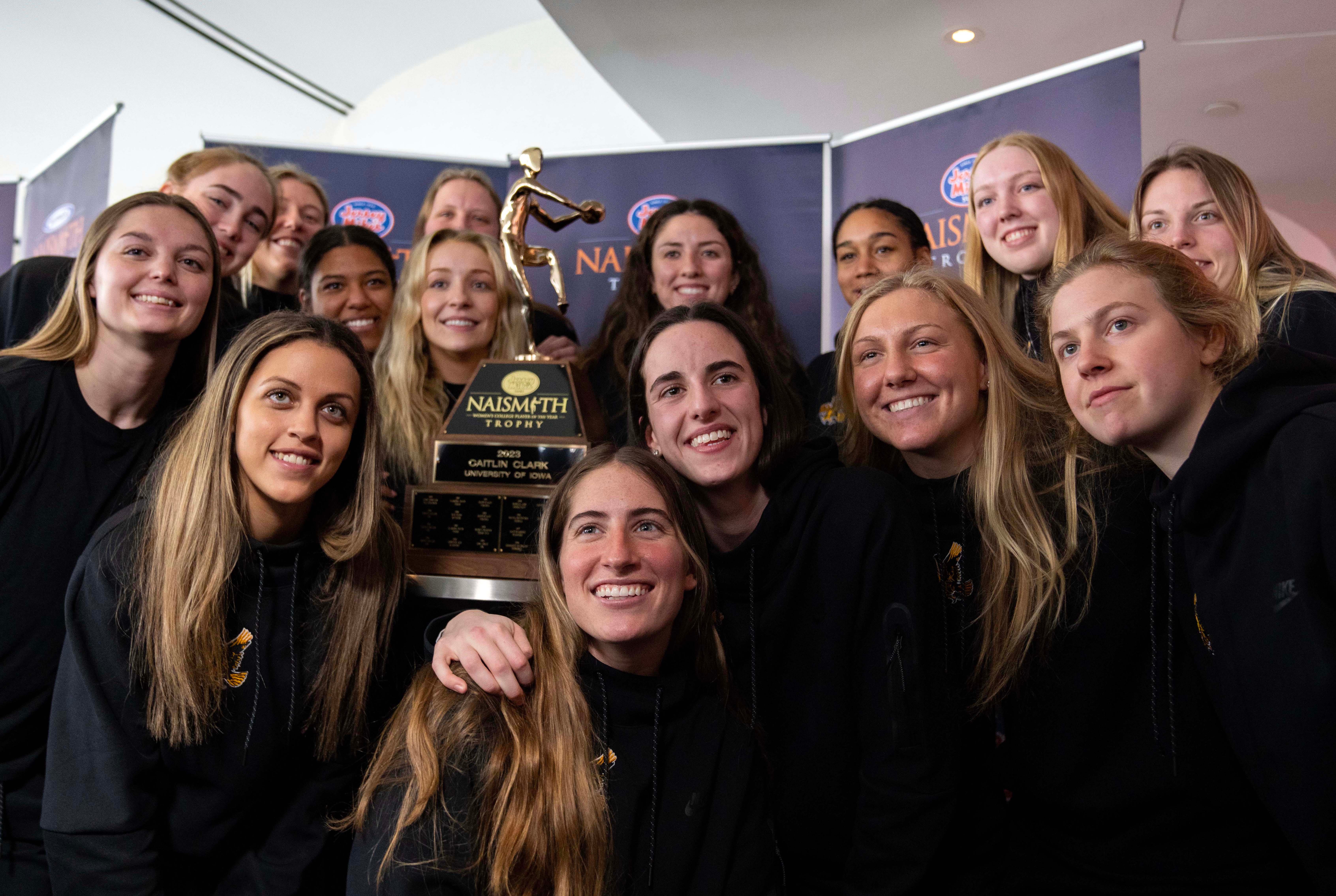 Caitlin Clark poses for photos with her team after winning the 2023 Jersey MikeÕs Naismith Trophy in Dallas, Texas, Wednesday, March 29, 2023.